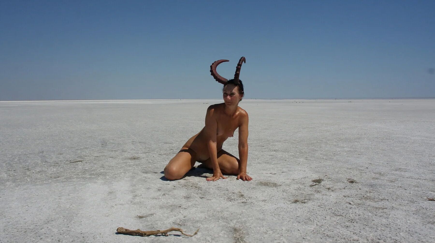 Standing naked on the salt of the salt lake Elton