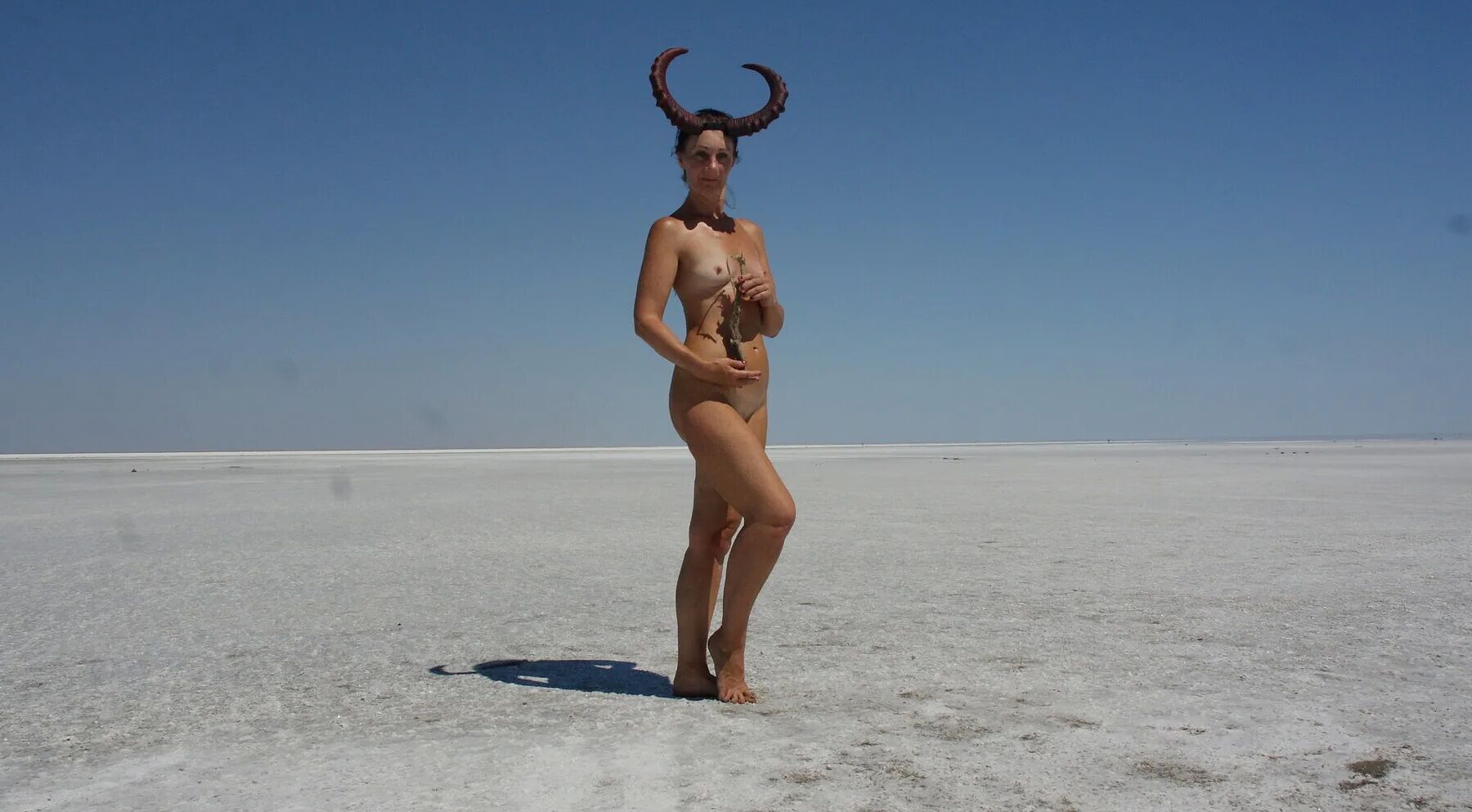 Standing naked on the salt of the salt lake Elton