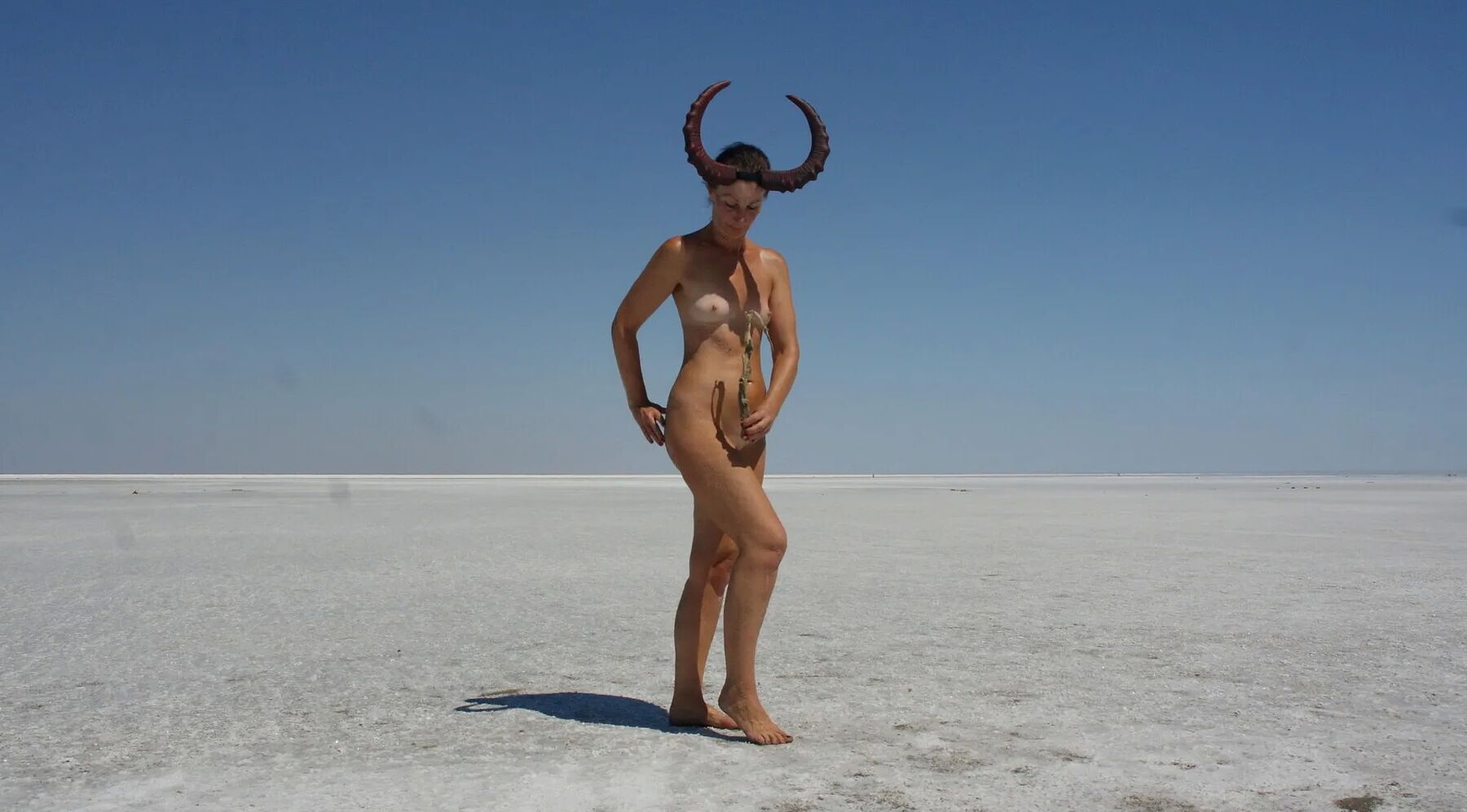 Standing naked on the salt of the salt lake Elton