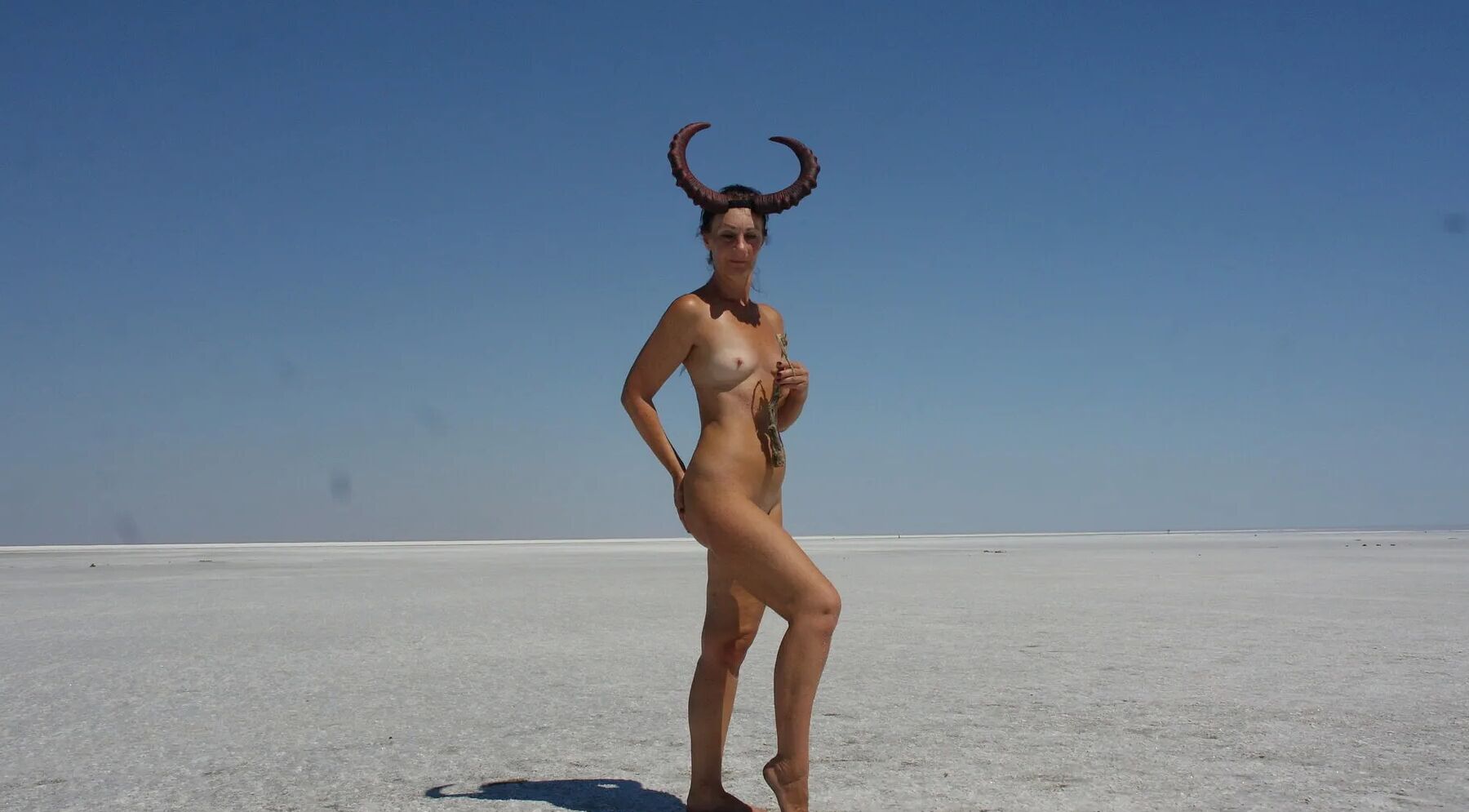 Standing naked on the salt of the salt lake Elton