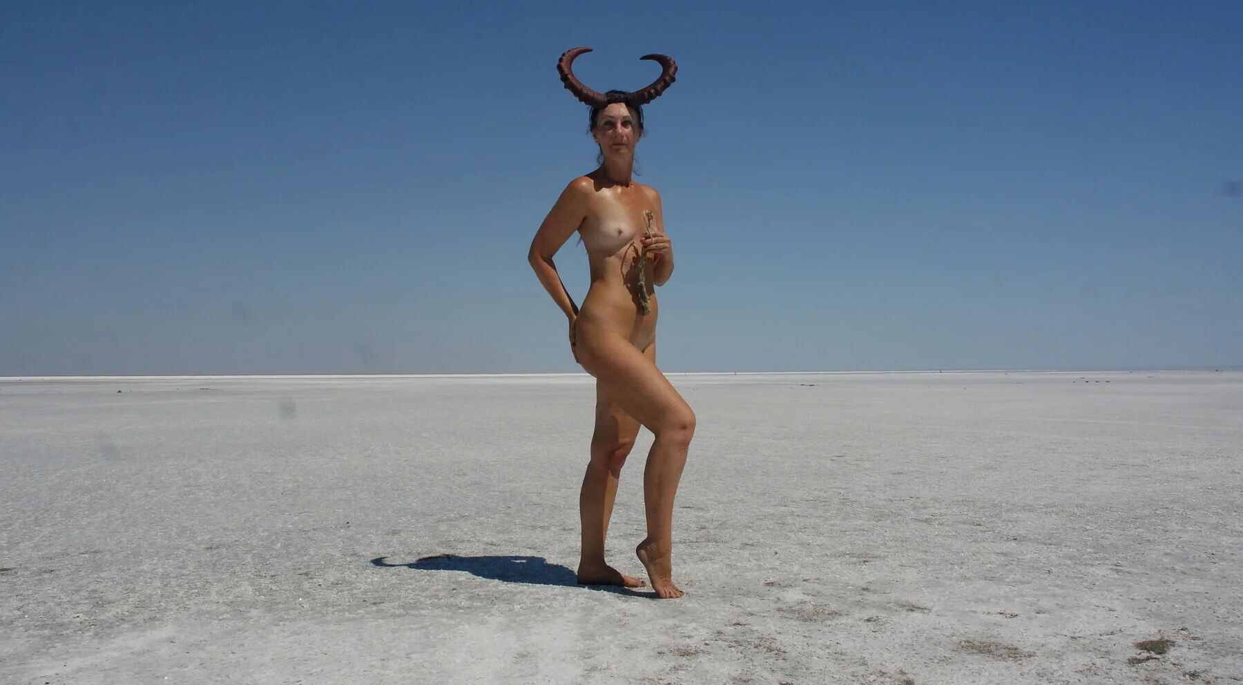 Standing naked on the salt of the salt lake Elton
