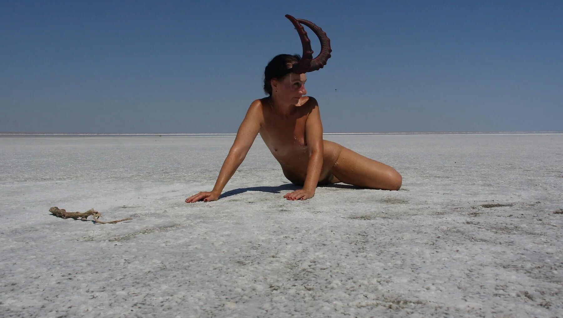 Standing on laps naked on the salt of the salt lake Elton