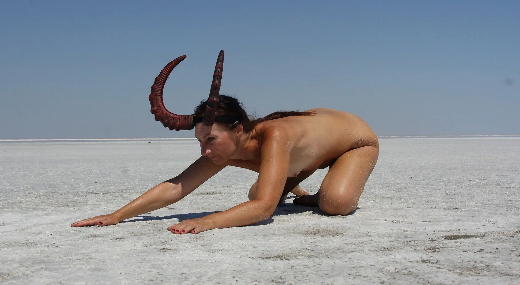 Standing on laps naked on the salt of the salt lake Elton