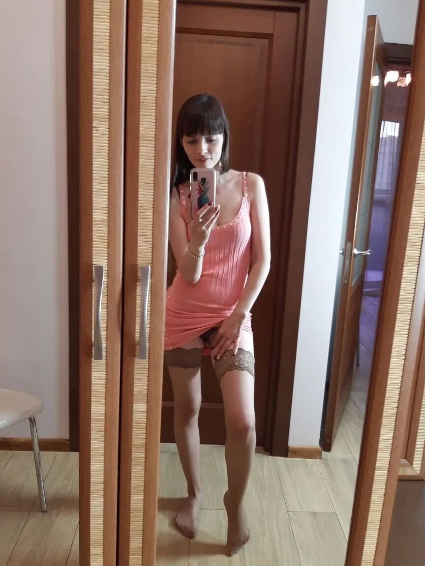 Sexy brunette secretary posing in hot stockings