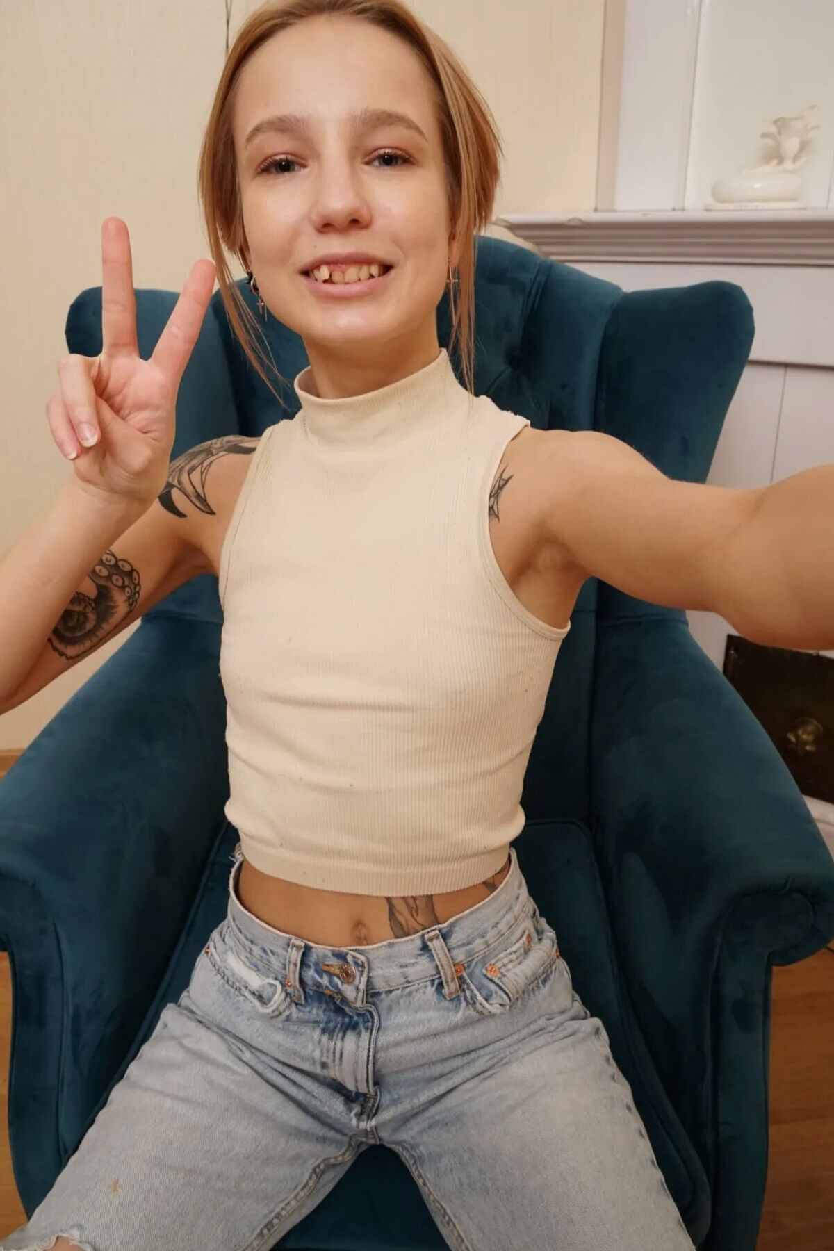 Skinny teen showing off her tattooed figure