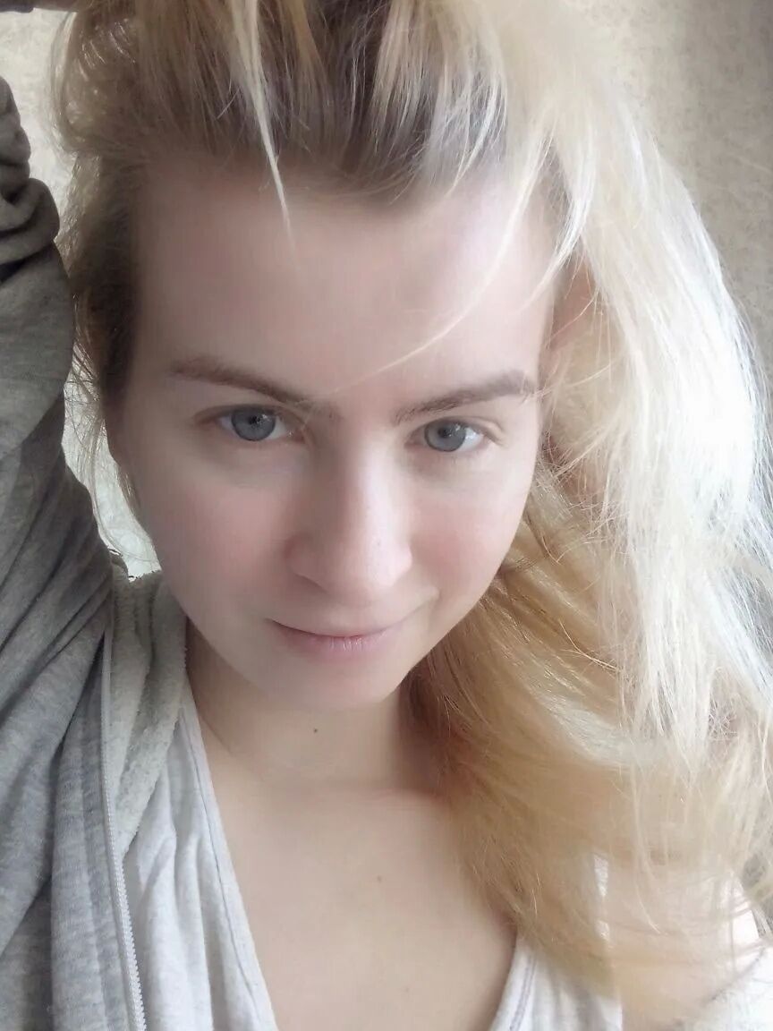Blue eyed beauty shows off her tiny tits