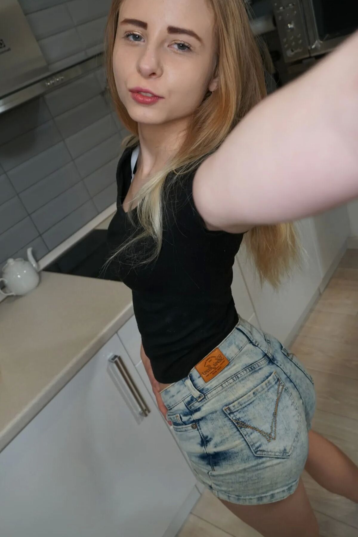 Petite perky girl takes nudes while smiling