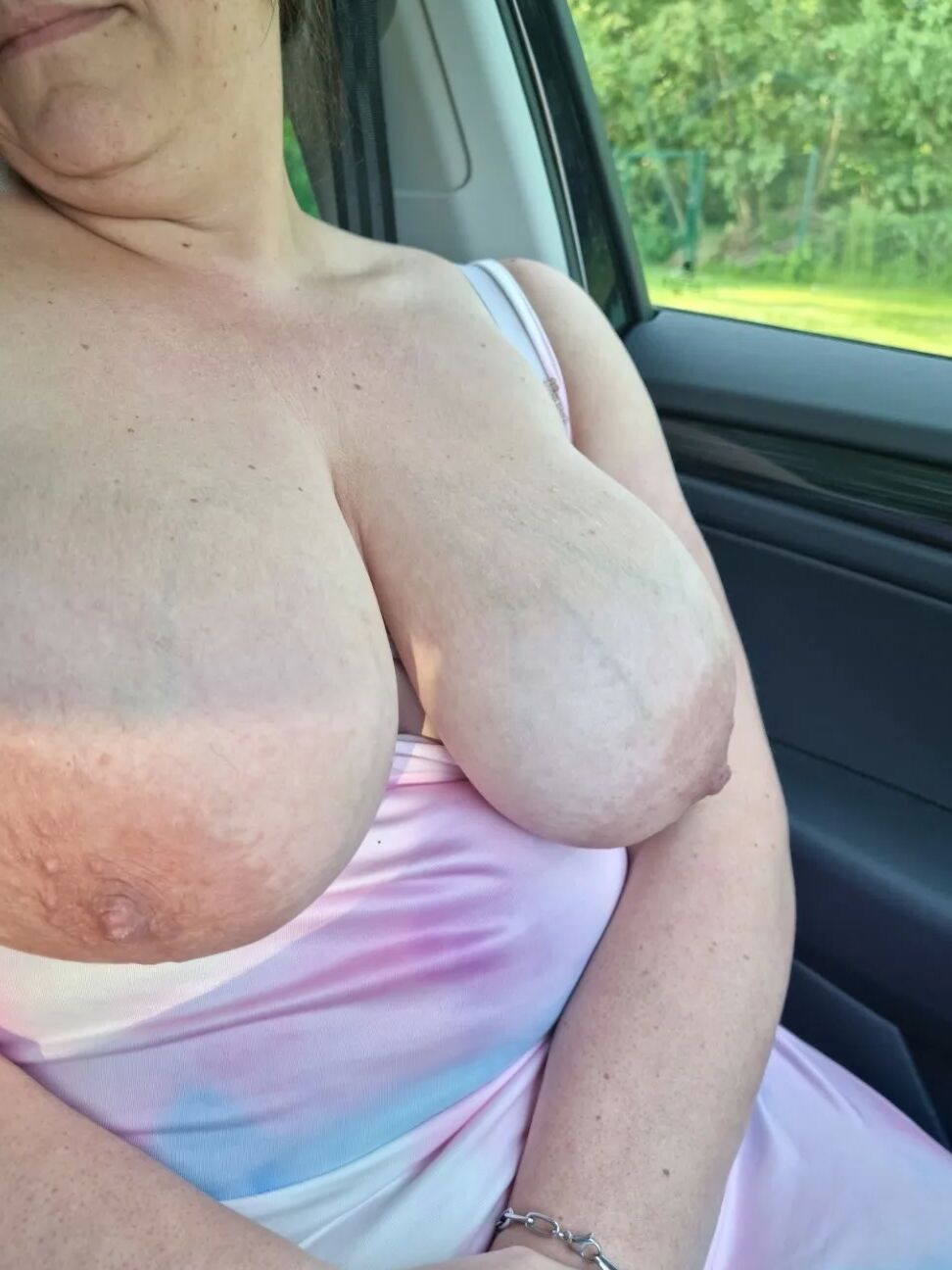 Busty milf showing her huge tits in car
