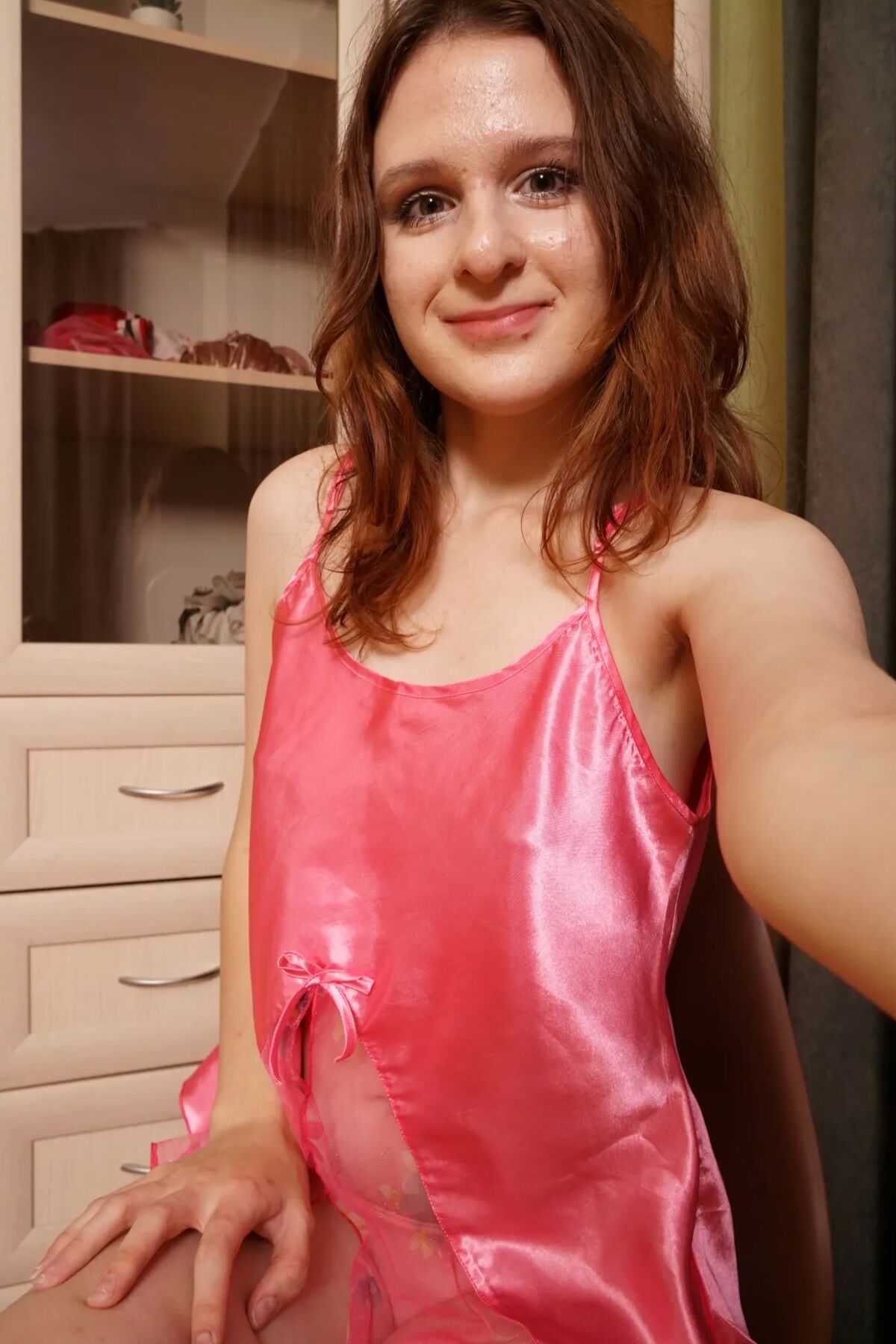 Redhead cutie shows off outfits and gets nude