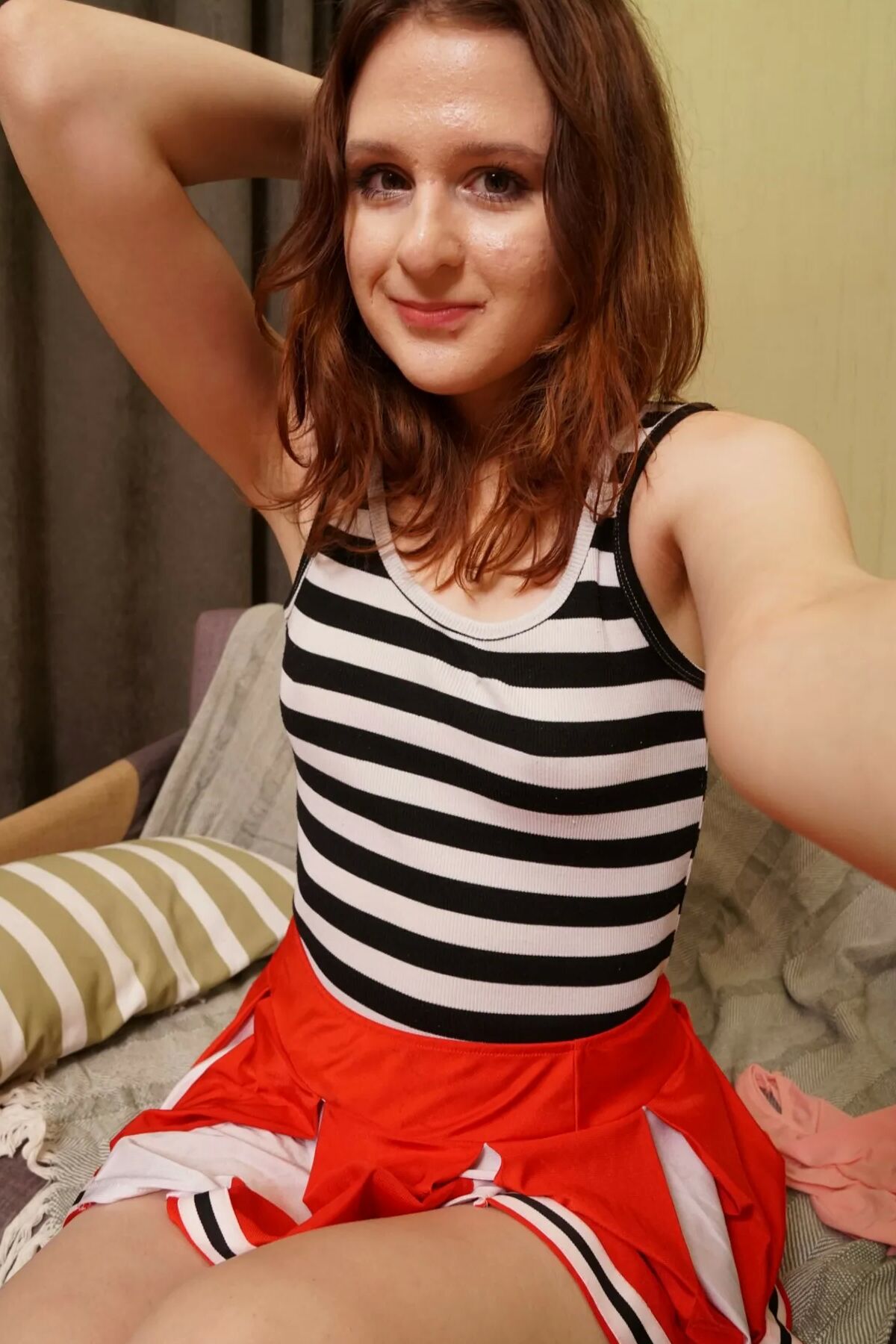 Redhead cutie shows off outfits and gets nude