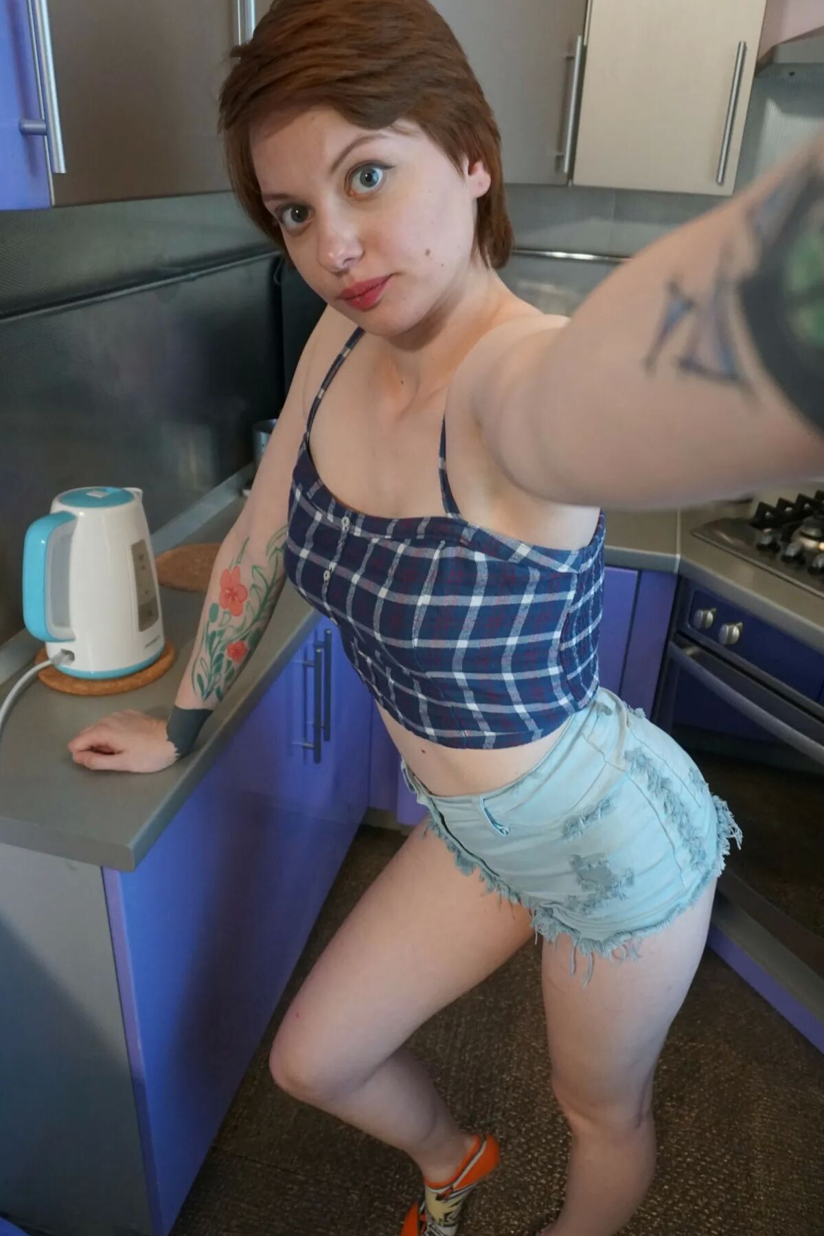 Sweet redhead gets naked in the office