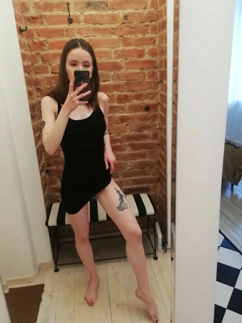 Skinny teen takes selfies in the mirror