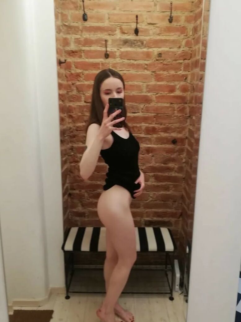 Skinny teen takes selfies in the mirror