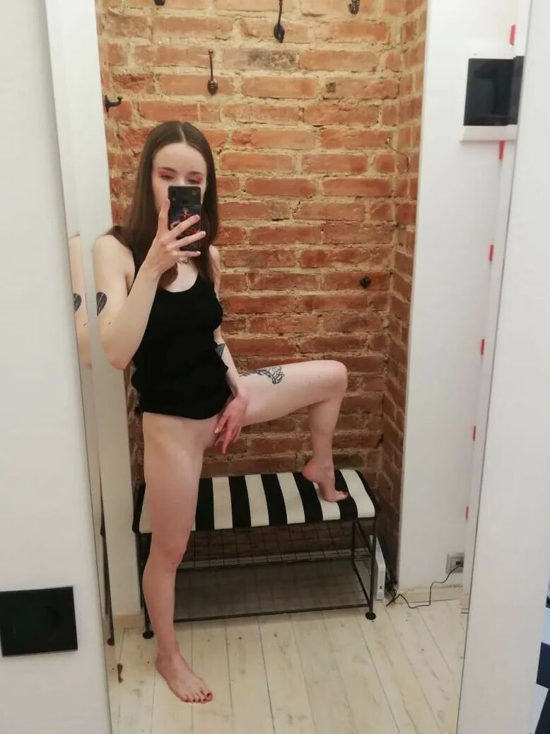 Skinny teen takes selfies in the mirror