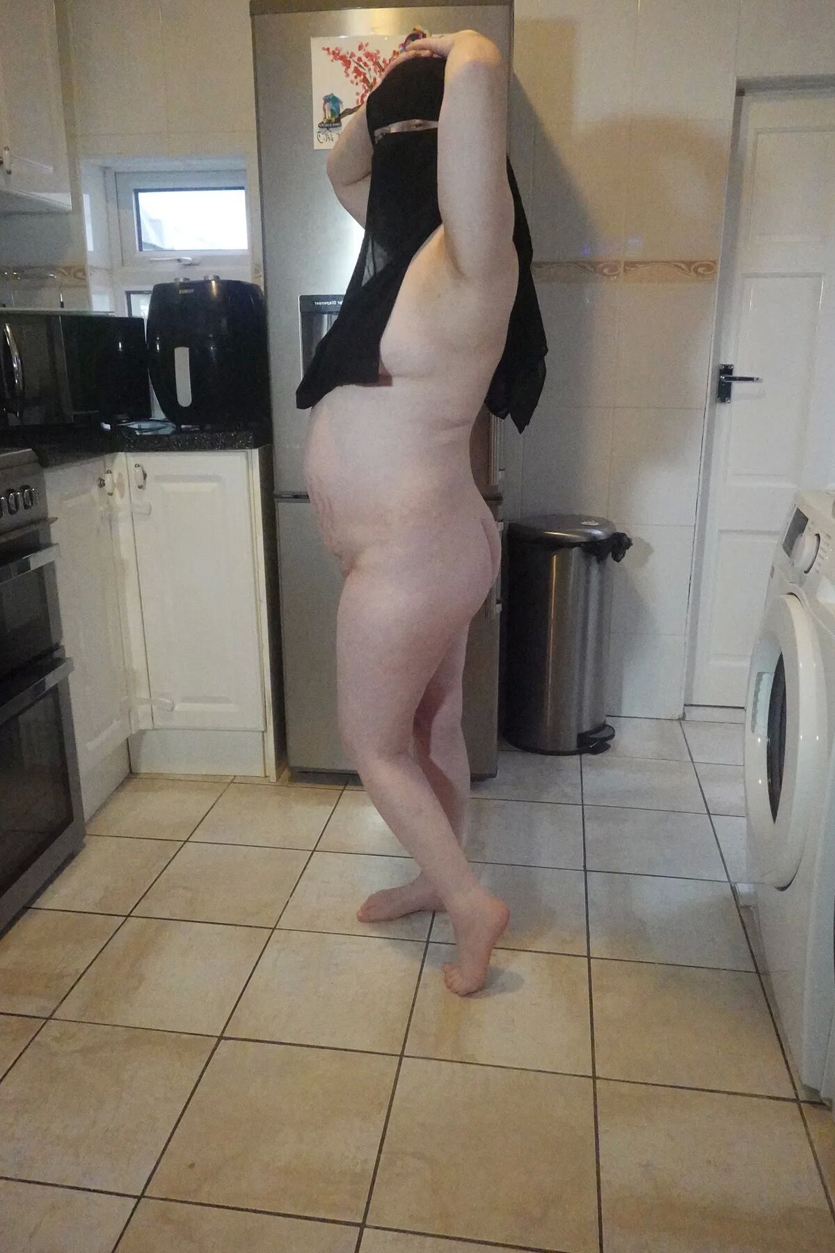 Posing fully nude in Niqab