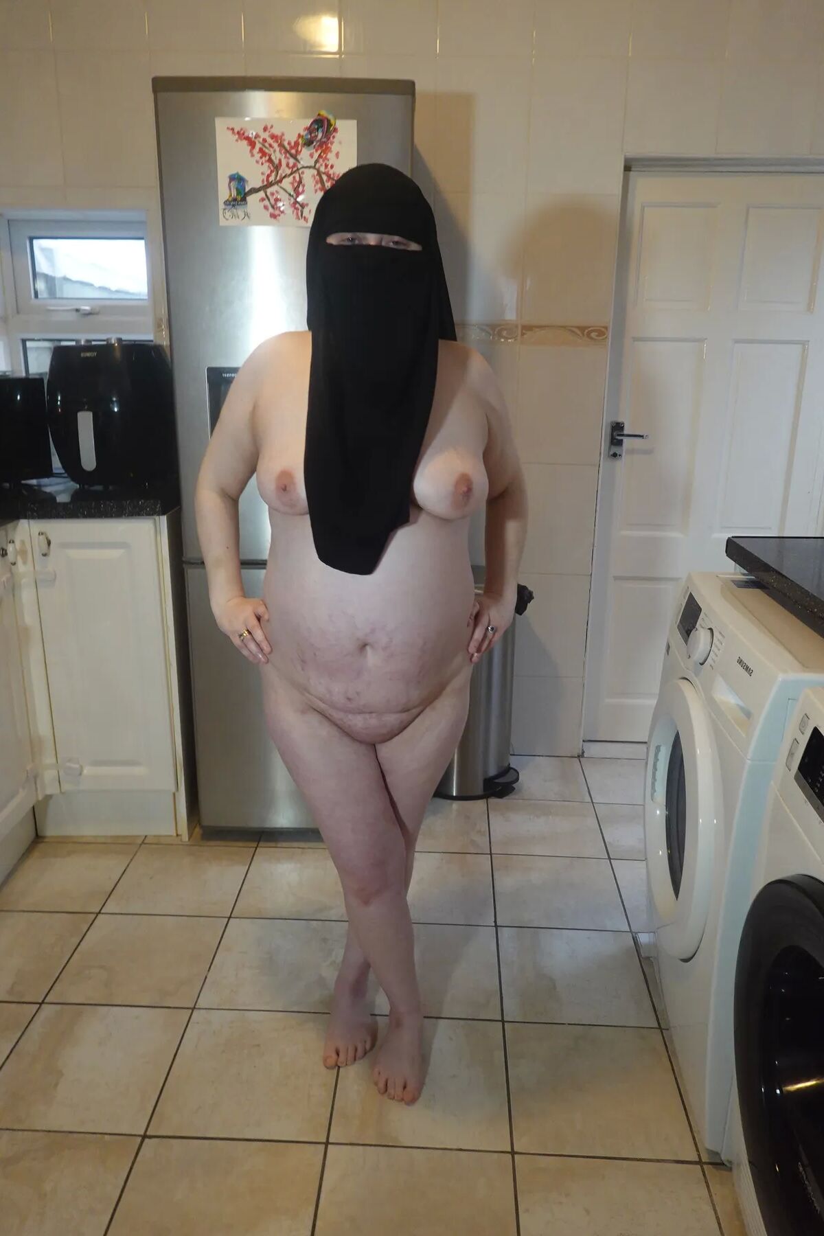 Posing fully nude in Niqab