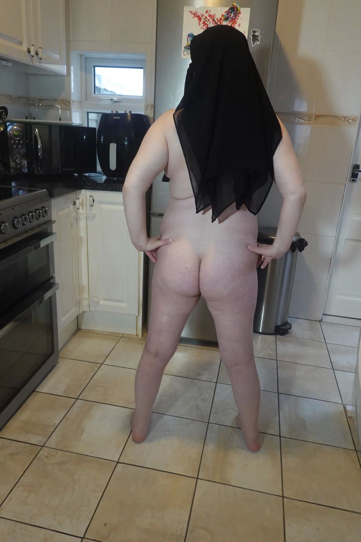 Posing fully nude in Niqab