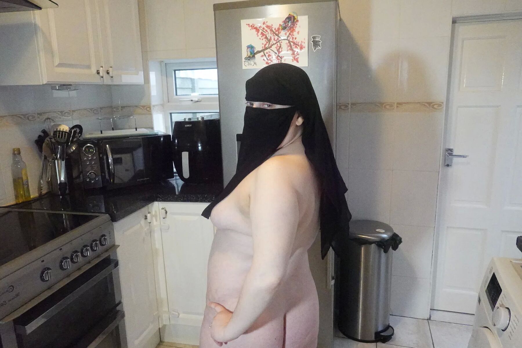 Posing fully nude in Niqab