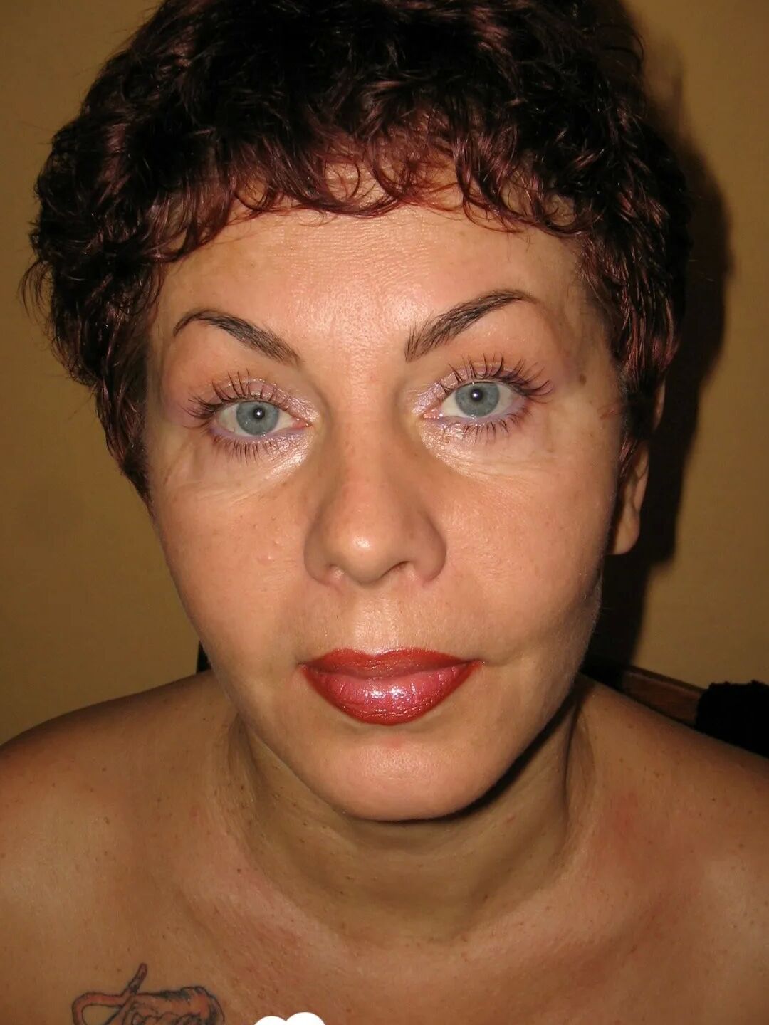 MILF in a fishnet masturbates with a whip