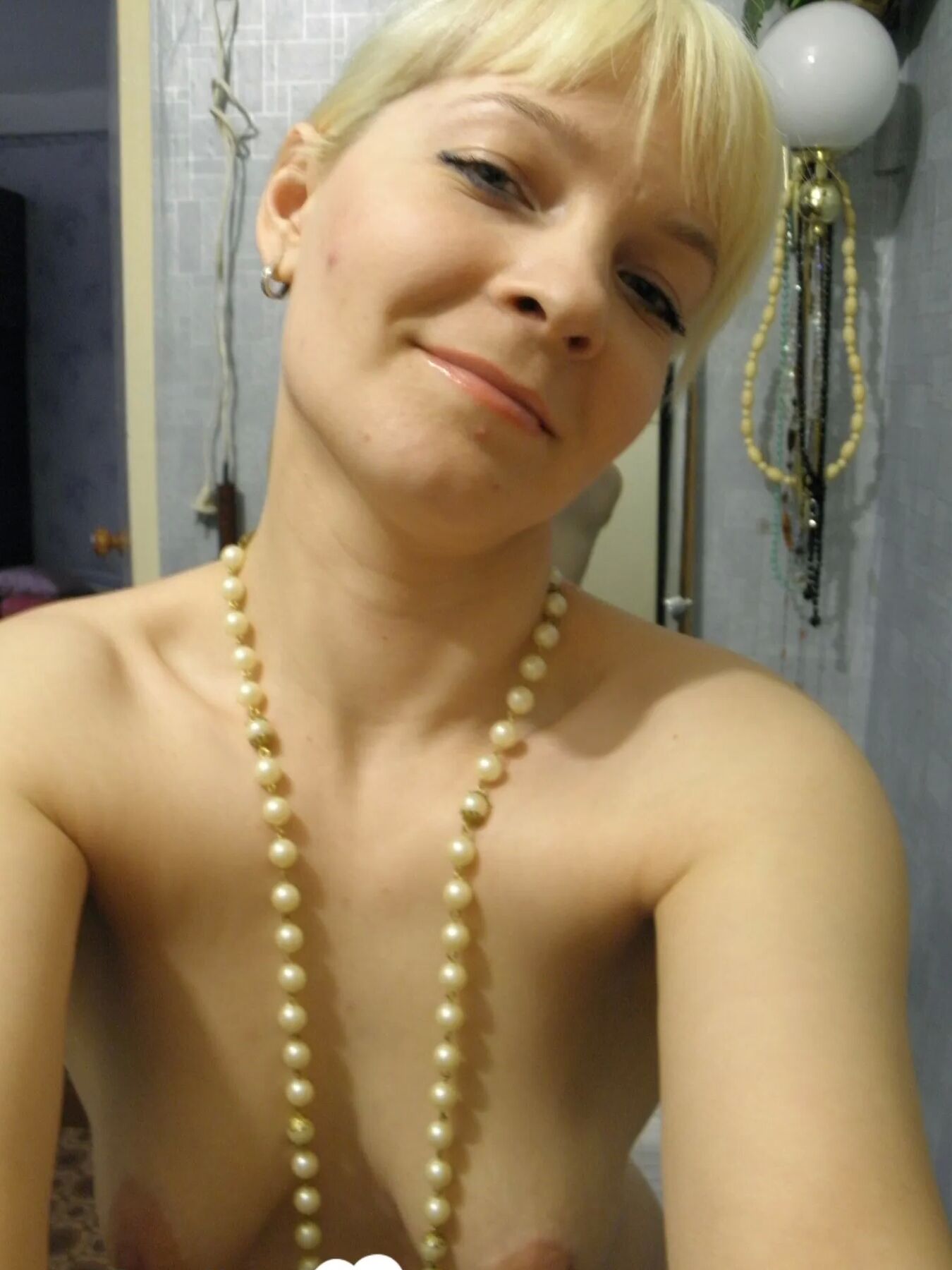Aroused blonde in stockings taking naughty selfies