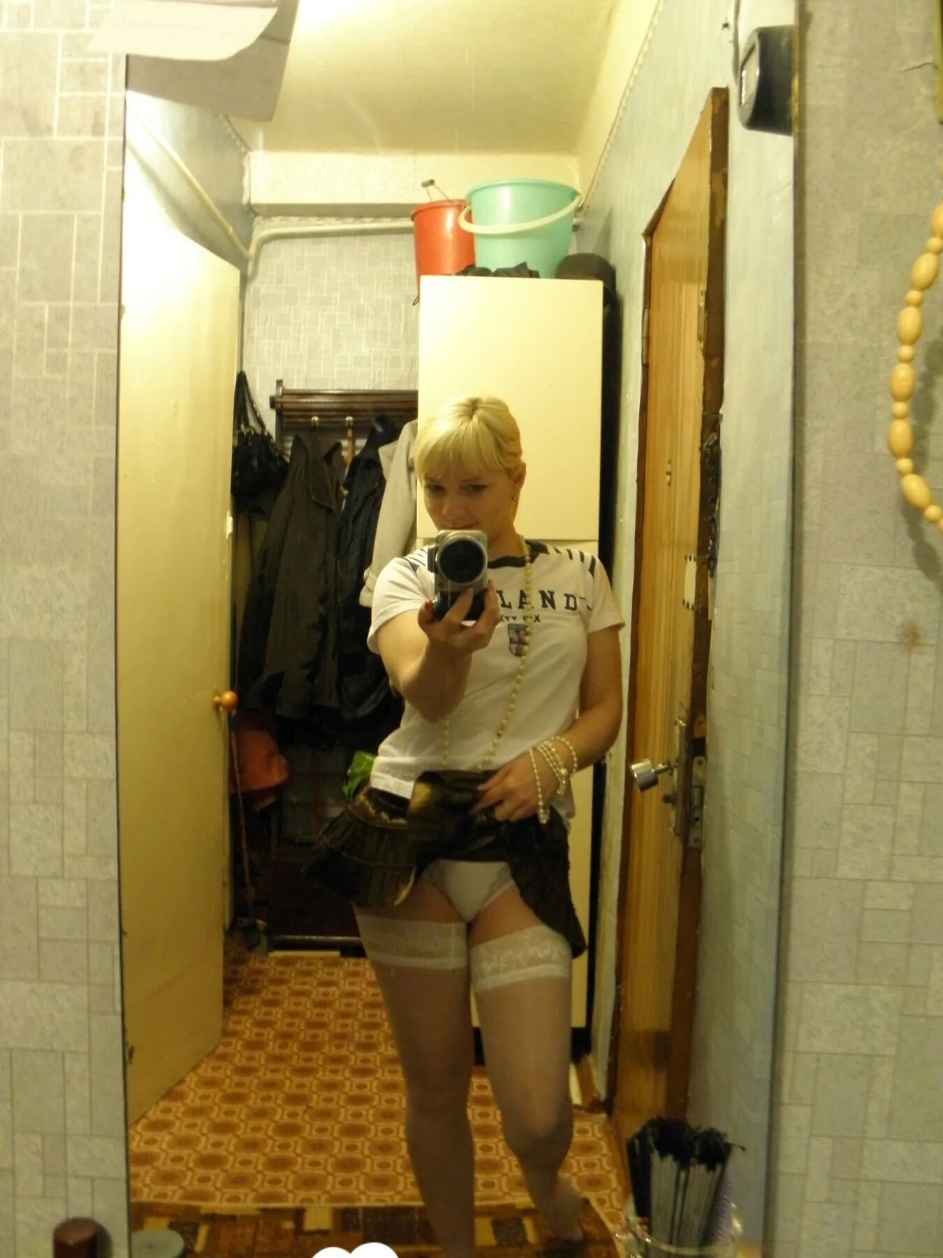 Aroused blonde in stockings taking naughty selfies