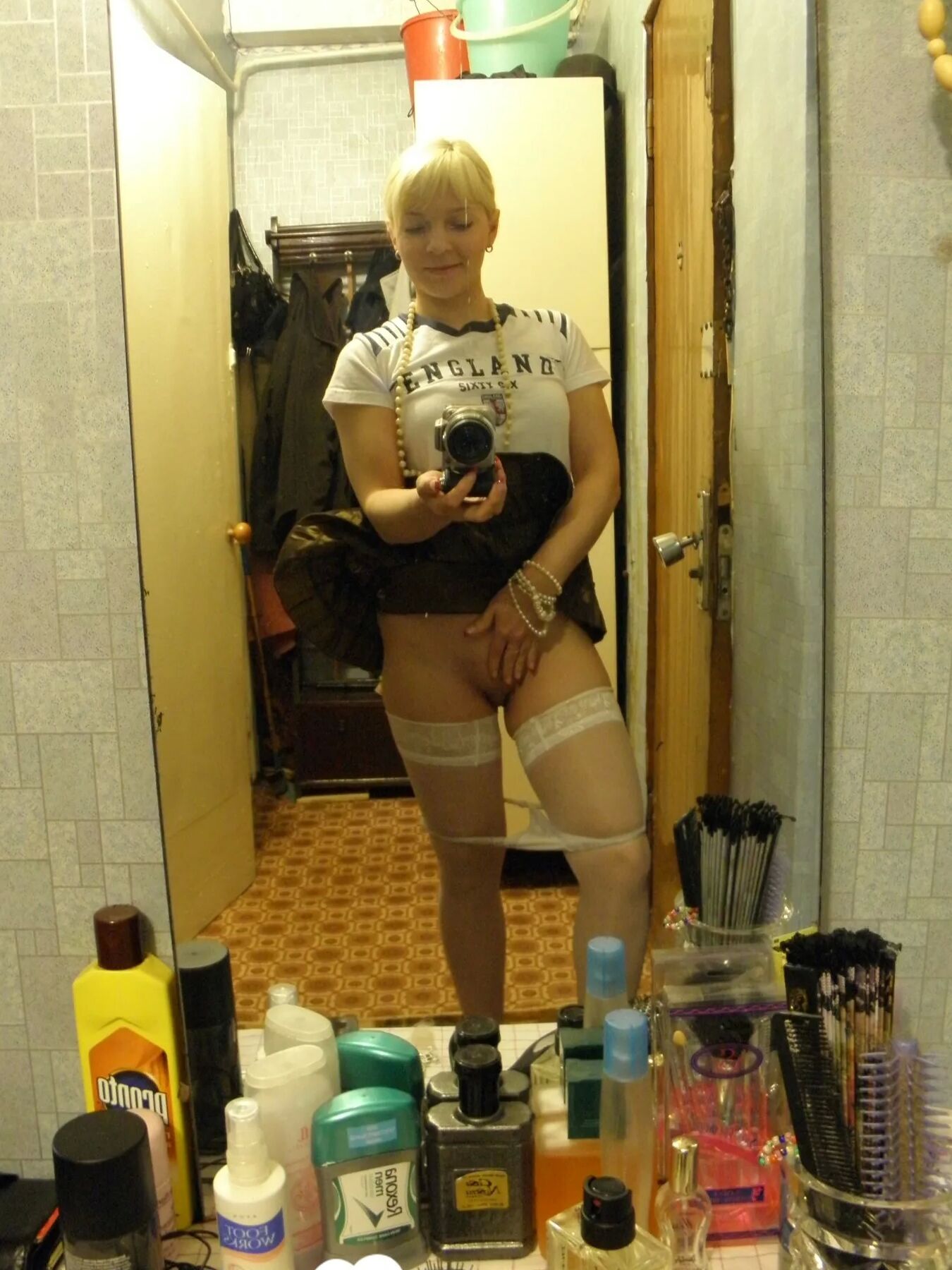 Aroused blonde in stockings taking naughty selfies