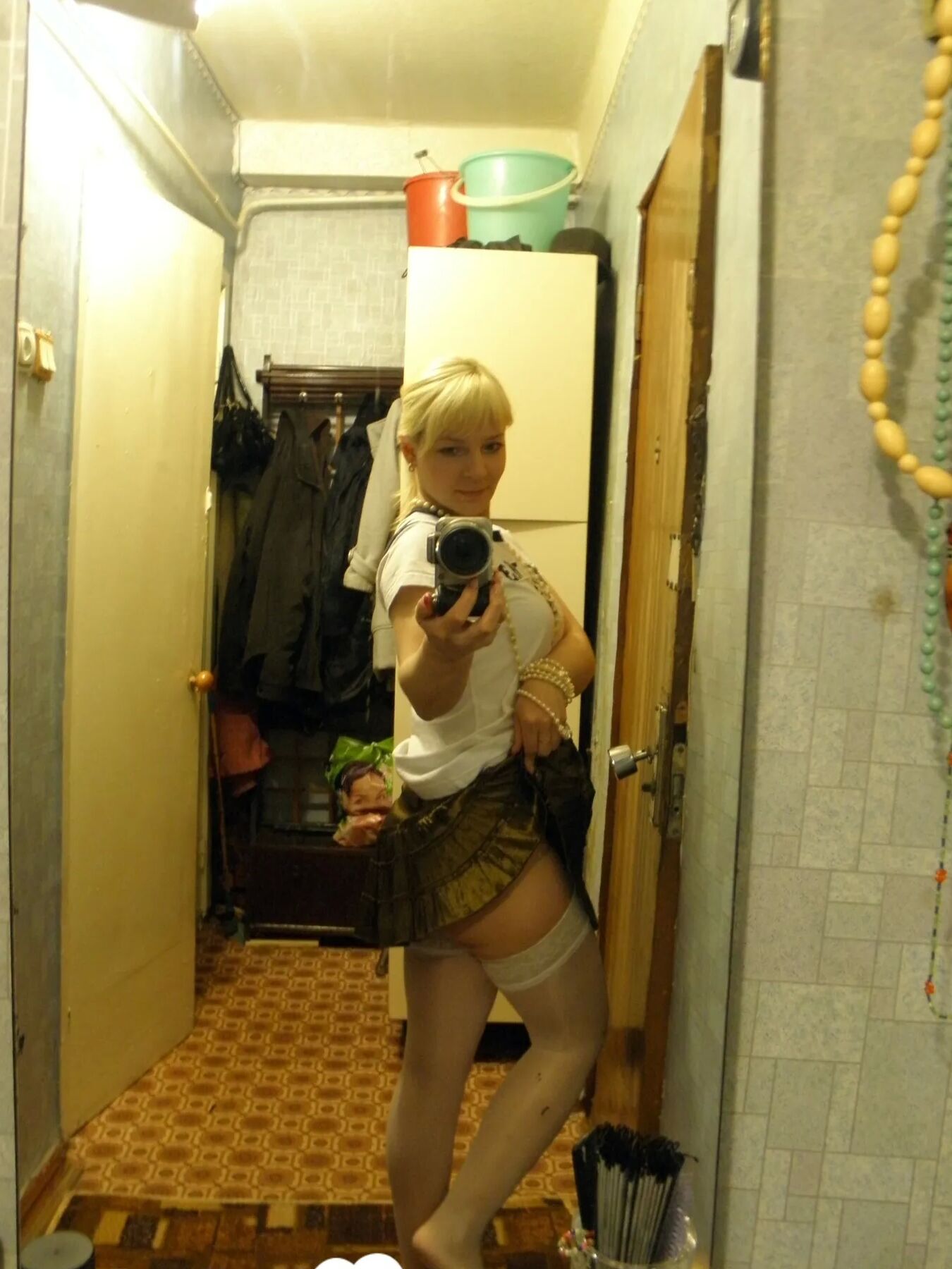Aroused blonde in stockings taking naughty selfies