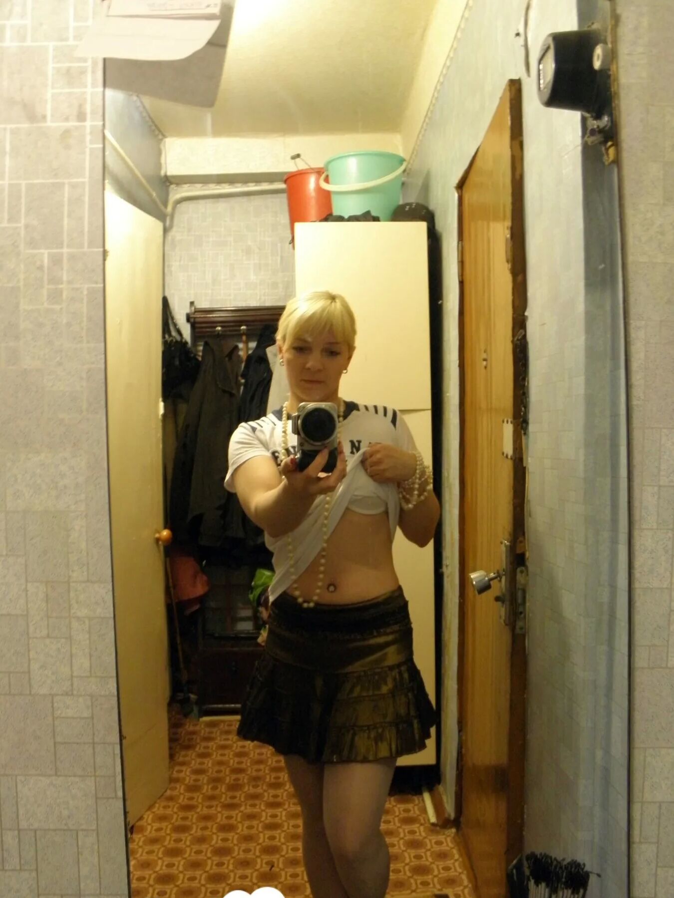 Aroused blonde in stockings taking naughty selfies