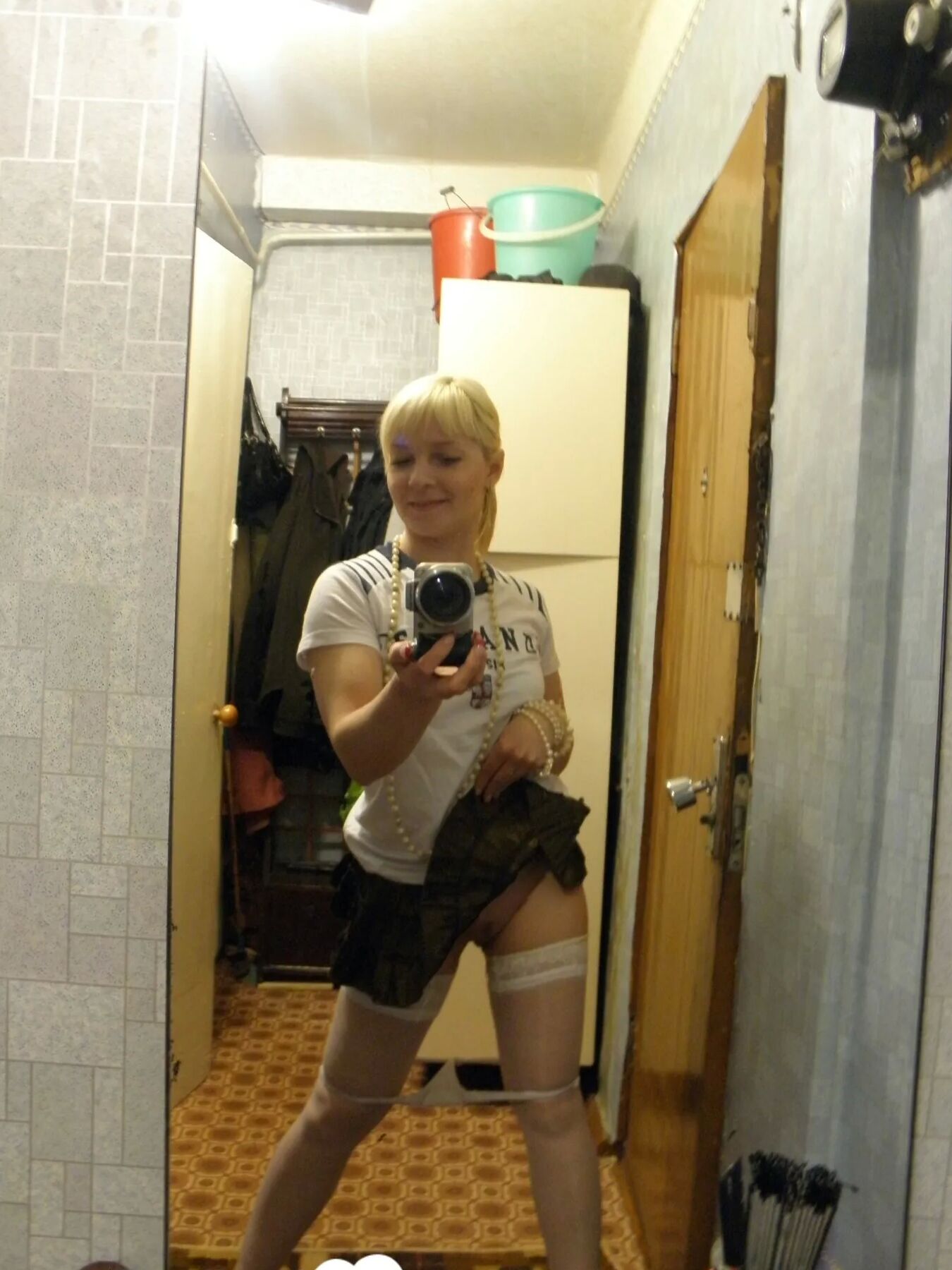 Aroused blonde in stockings taking naughty selfies