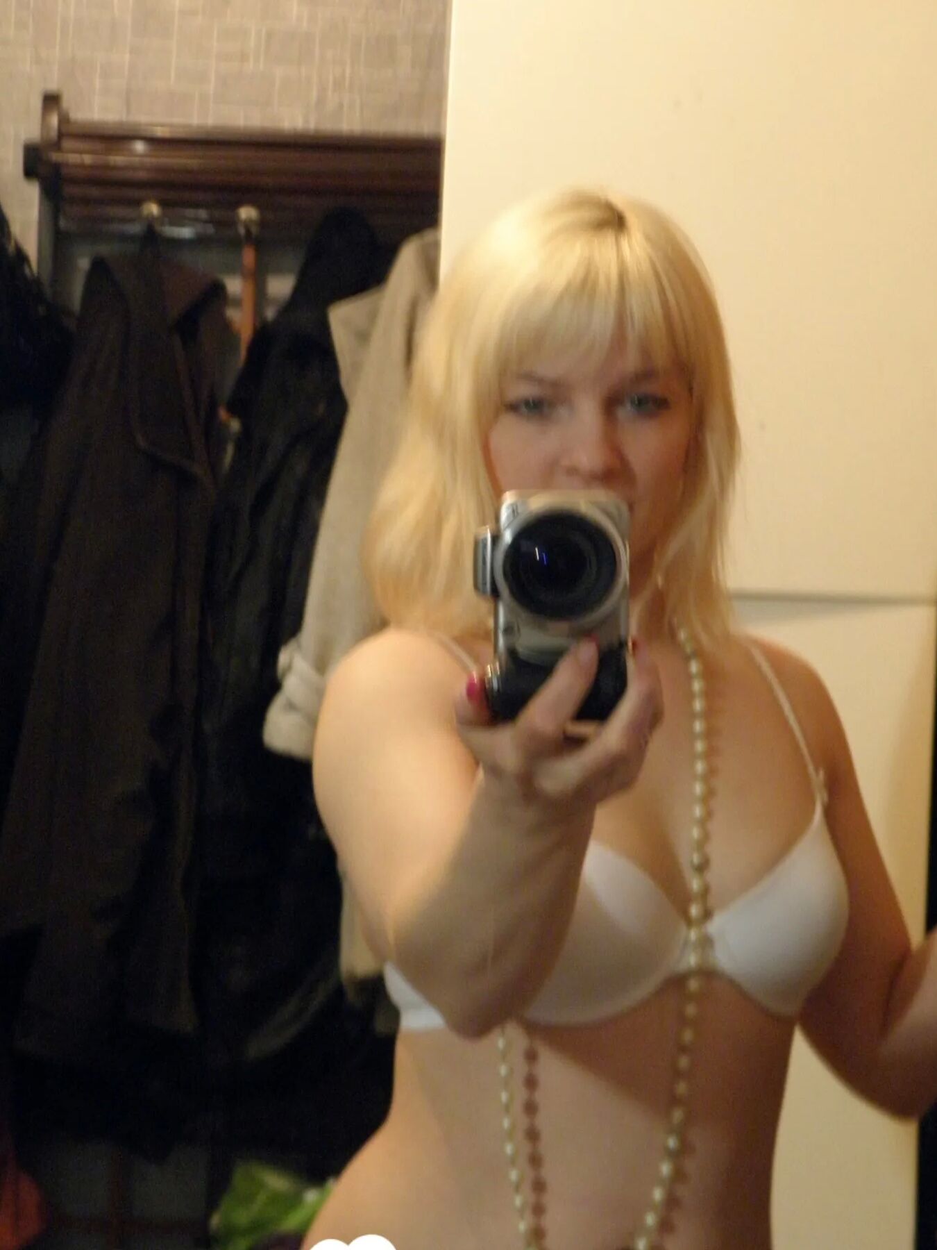 Aroused blonde in stockings taking naughty selfies