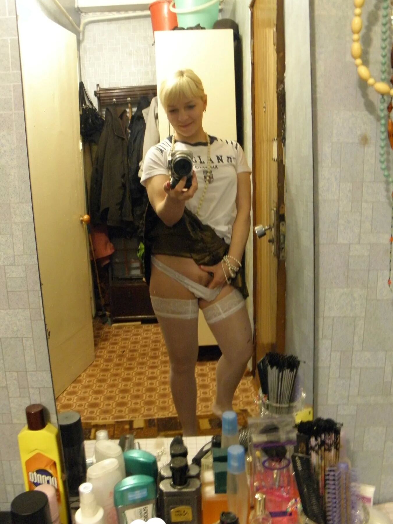 Aroused blonde in stockings taking naughty selfies
