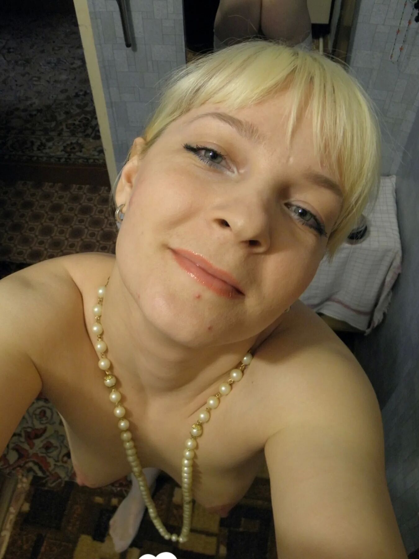 Aroused blonde in stockings taking naughty selfies
