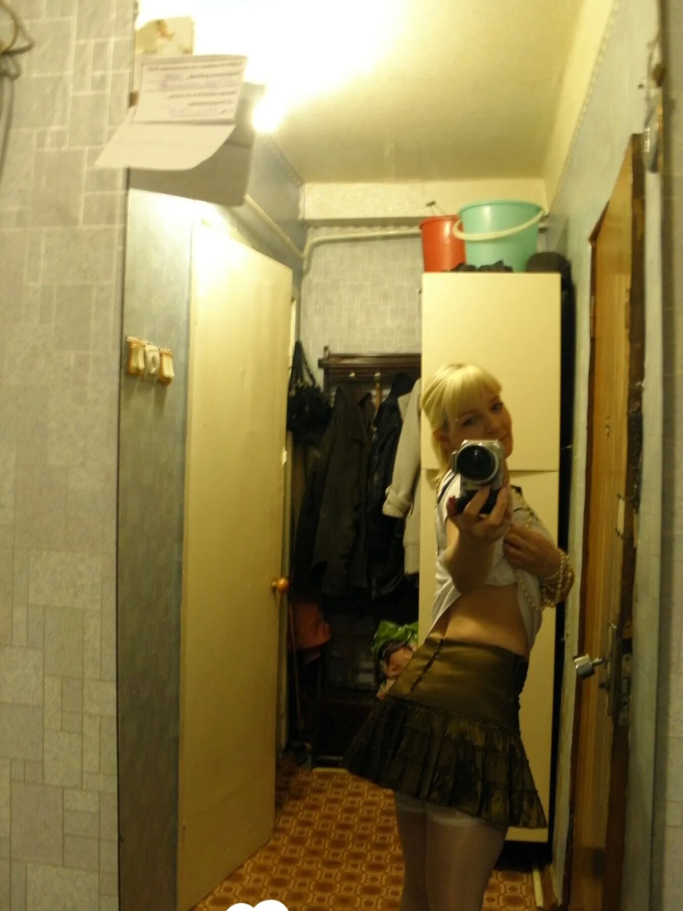 Aroused blonde in stockings taking naughty selfies