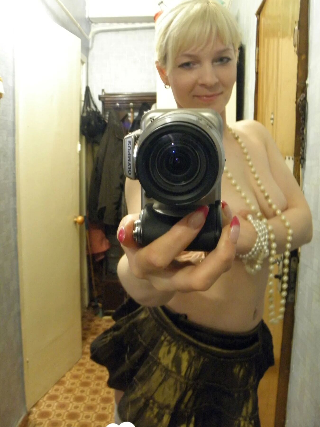 Aroused blonde in stockings taking naughty selfies