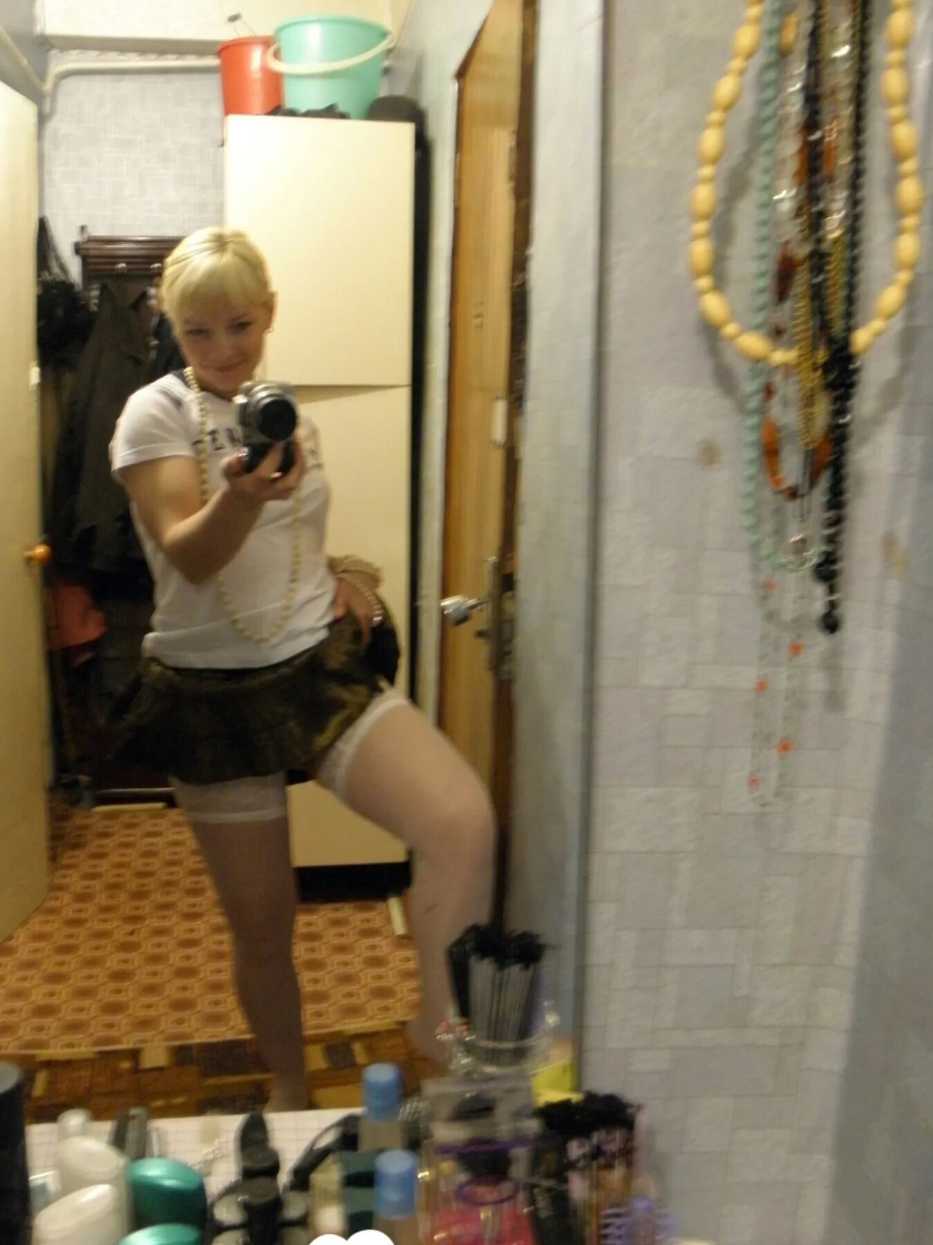 Aroused blonde in stockings taking naughty selfies