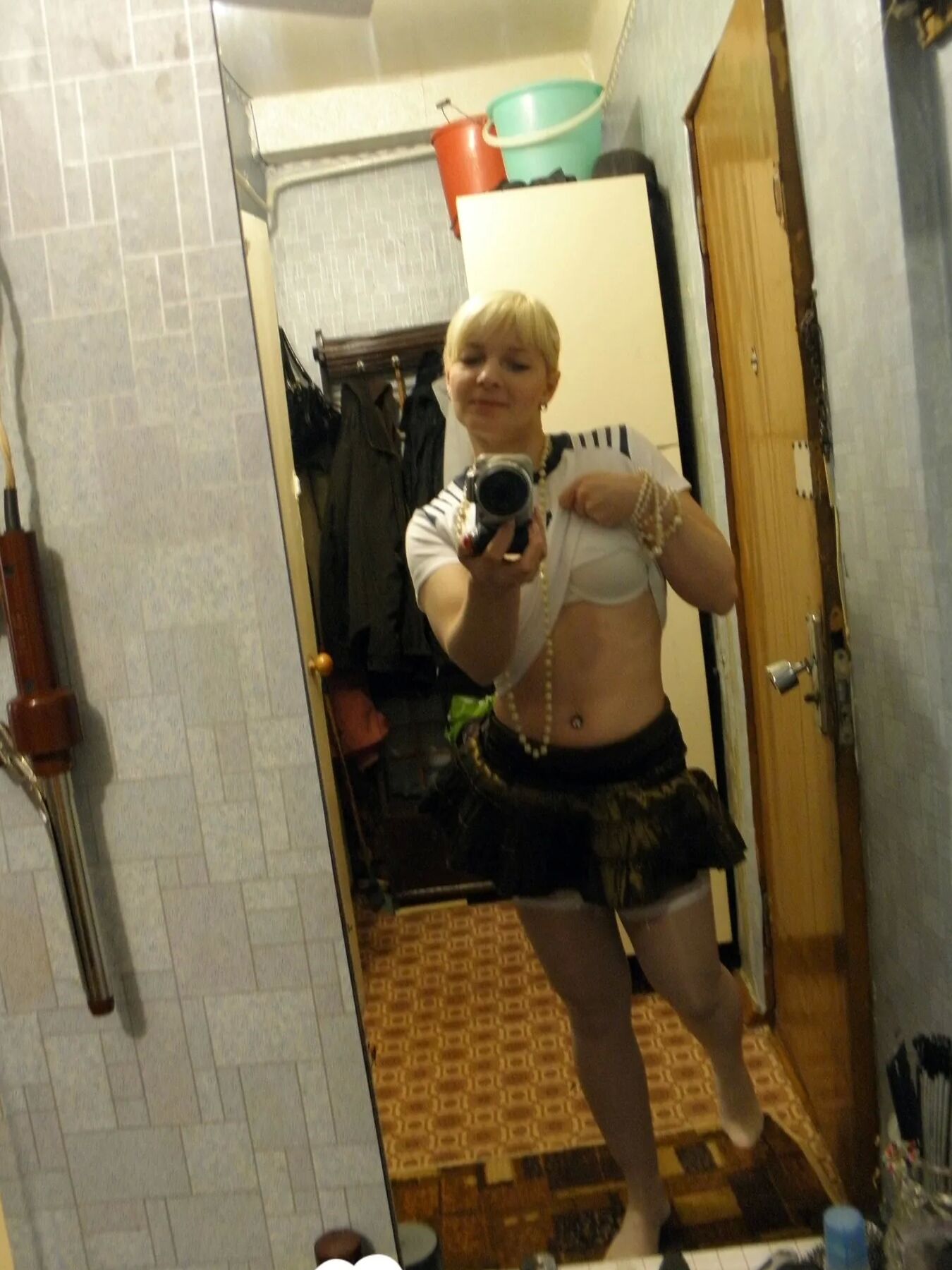 Aroused blonde in stockings taking naughty selfies