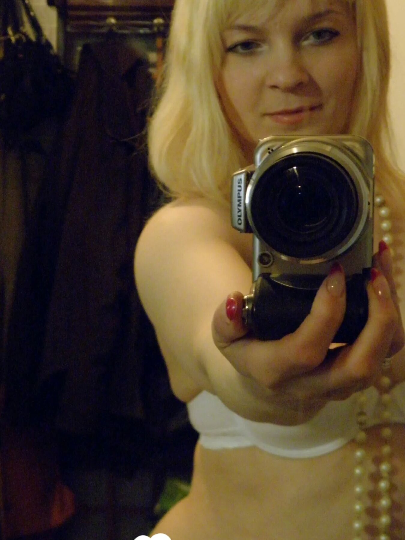 Aroused blonde in stockings taking naughty selfies