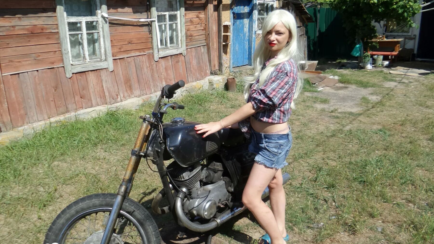 Blonde babe posing naked on a bike