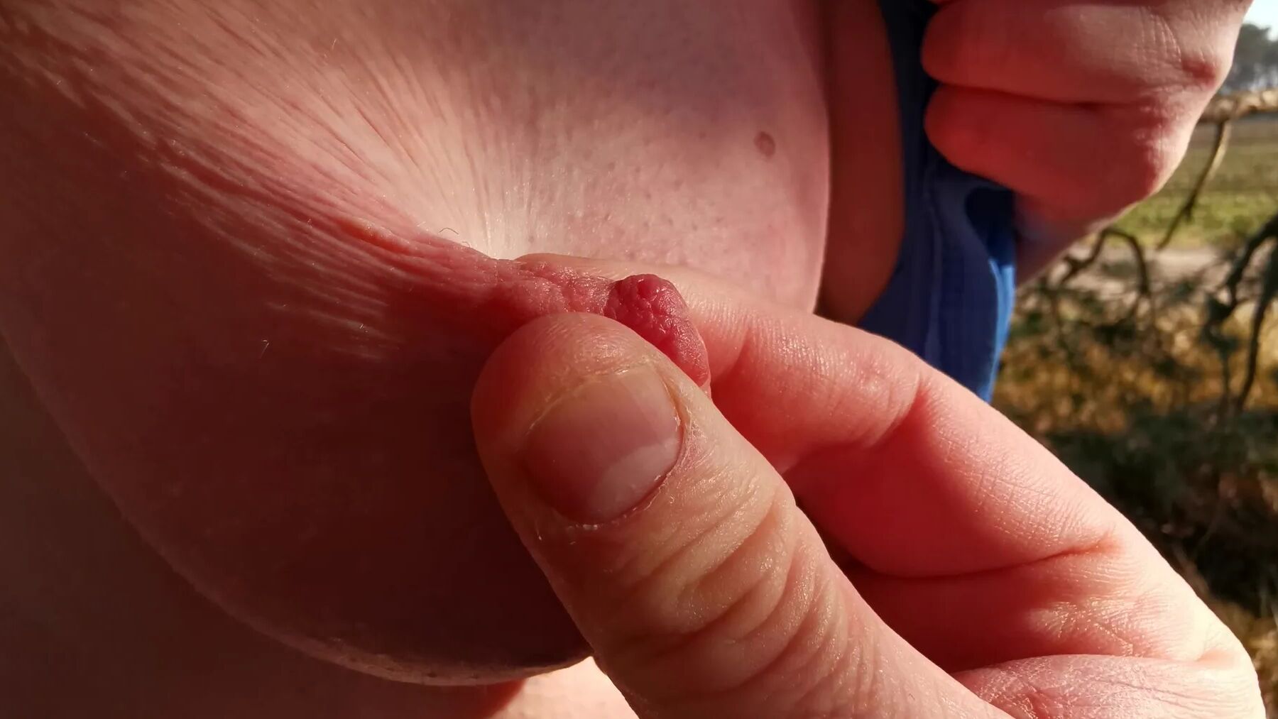 Nipple stretching outdoors