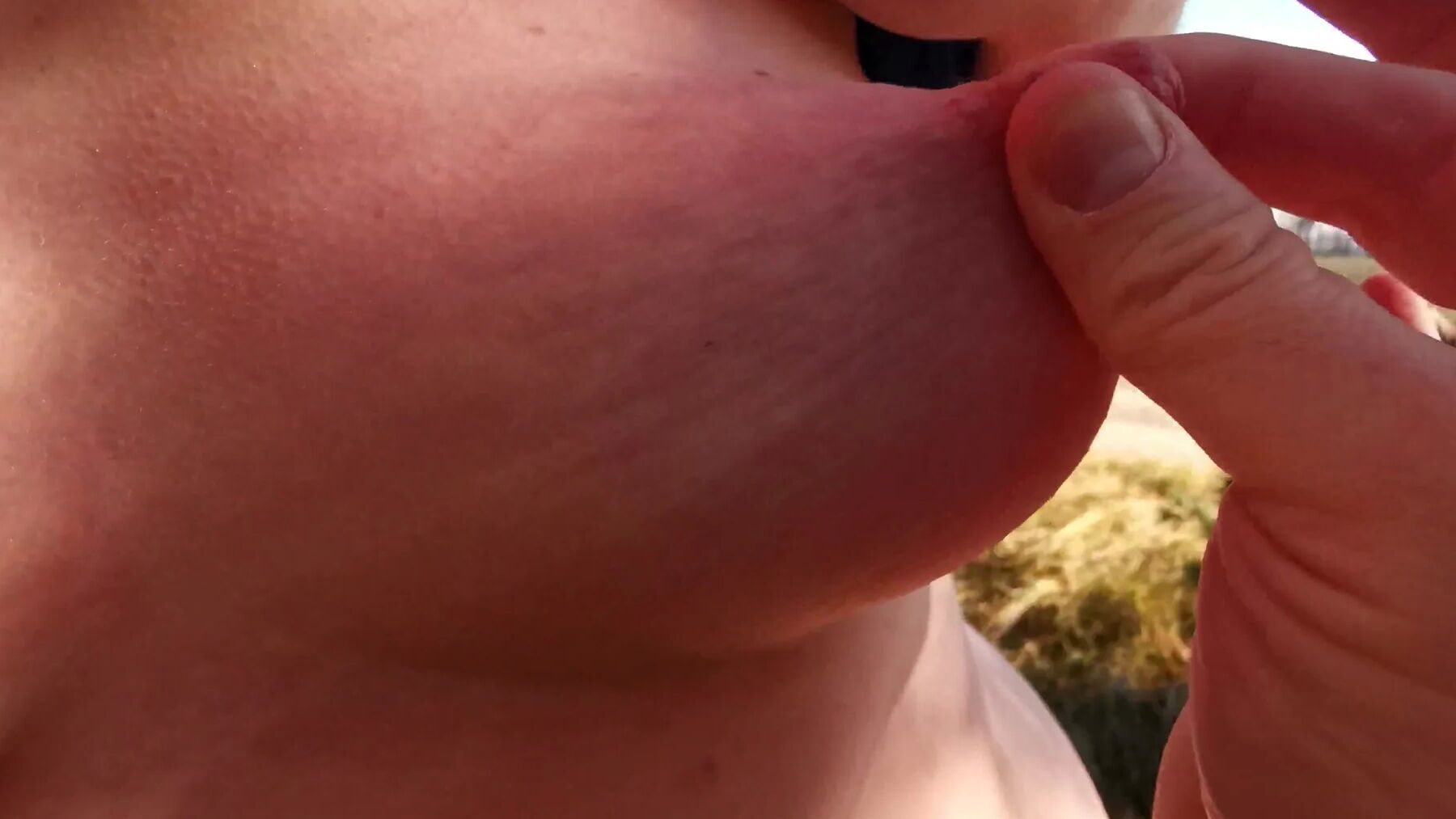Nipple stretching outdoors