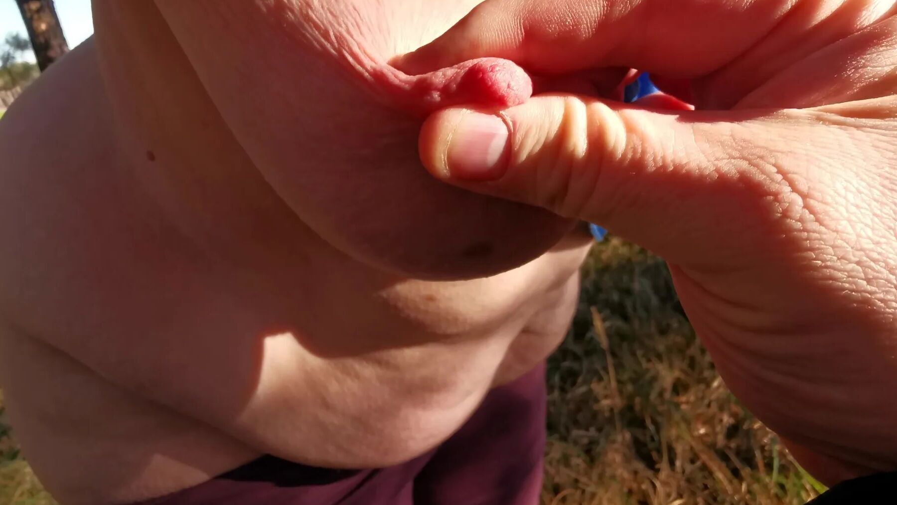 Nipple stretching outdoors