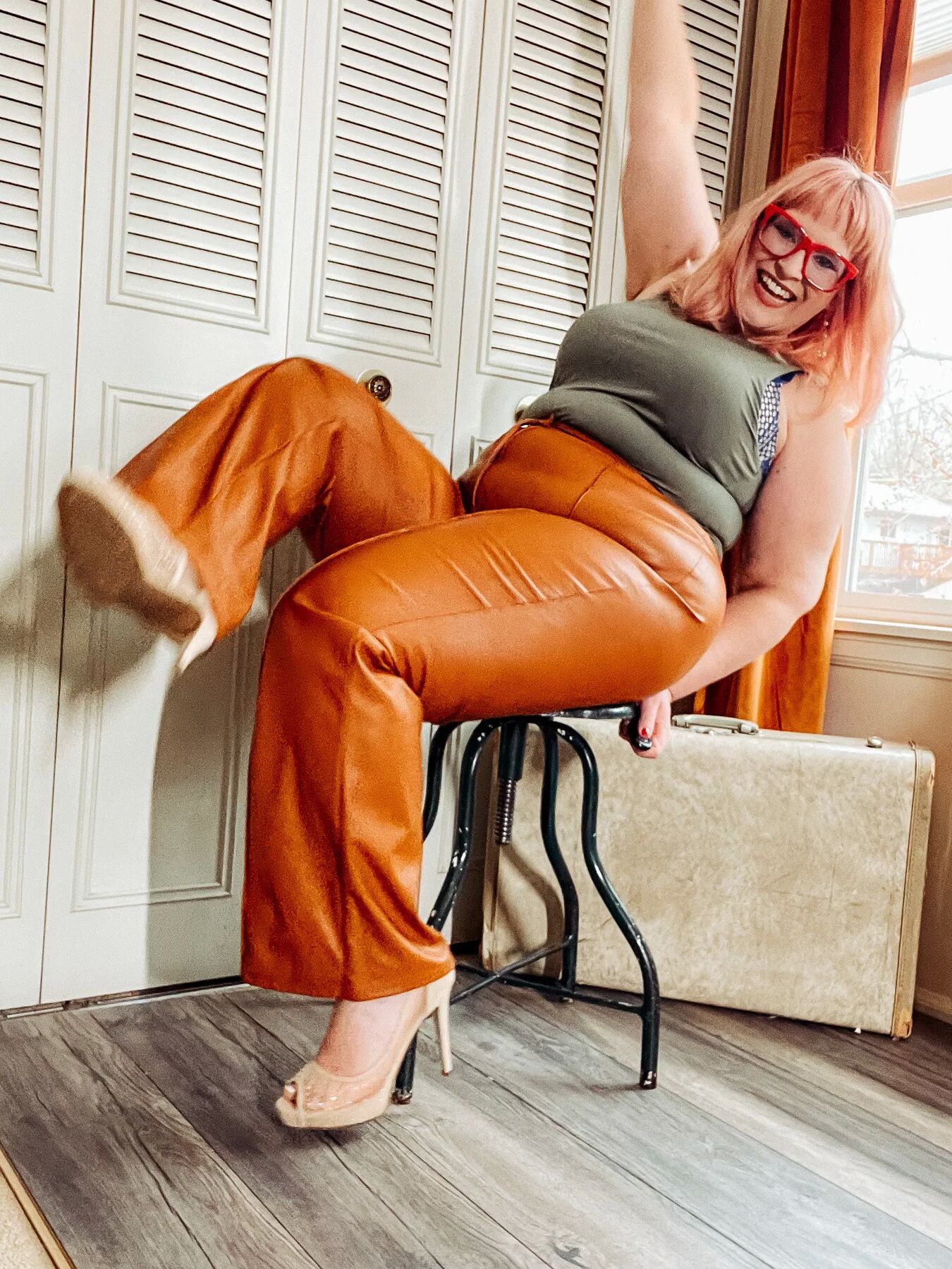 BBW in tight leather pants leans over and shows off her ass
