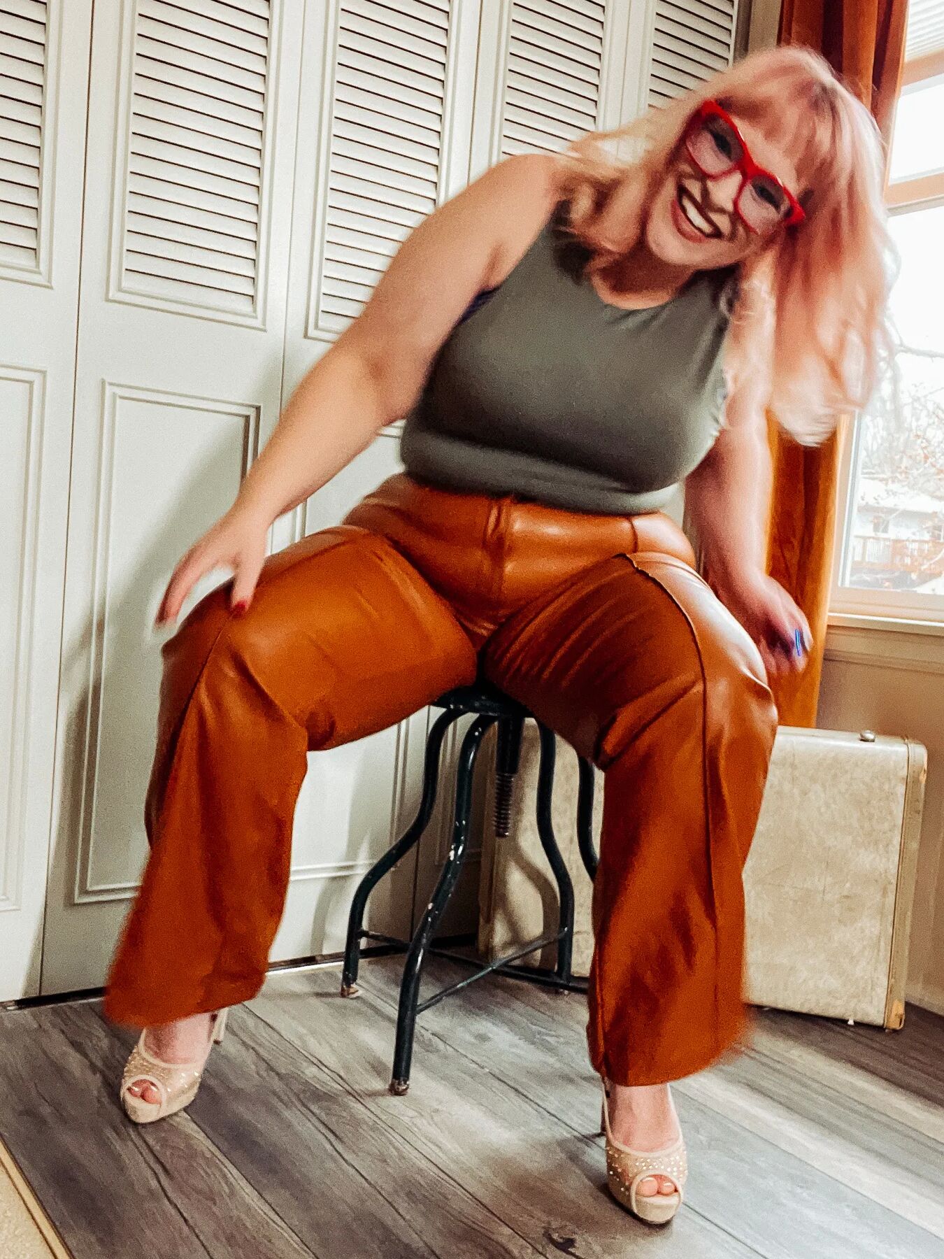 BBW in tight leather pants leans over and shows off her ass