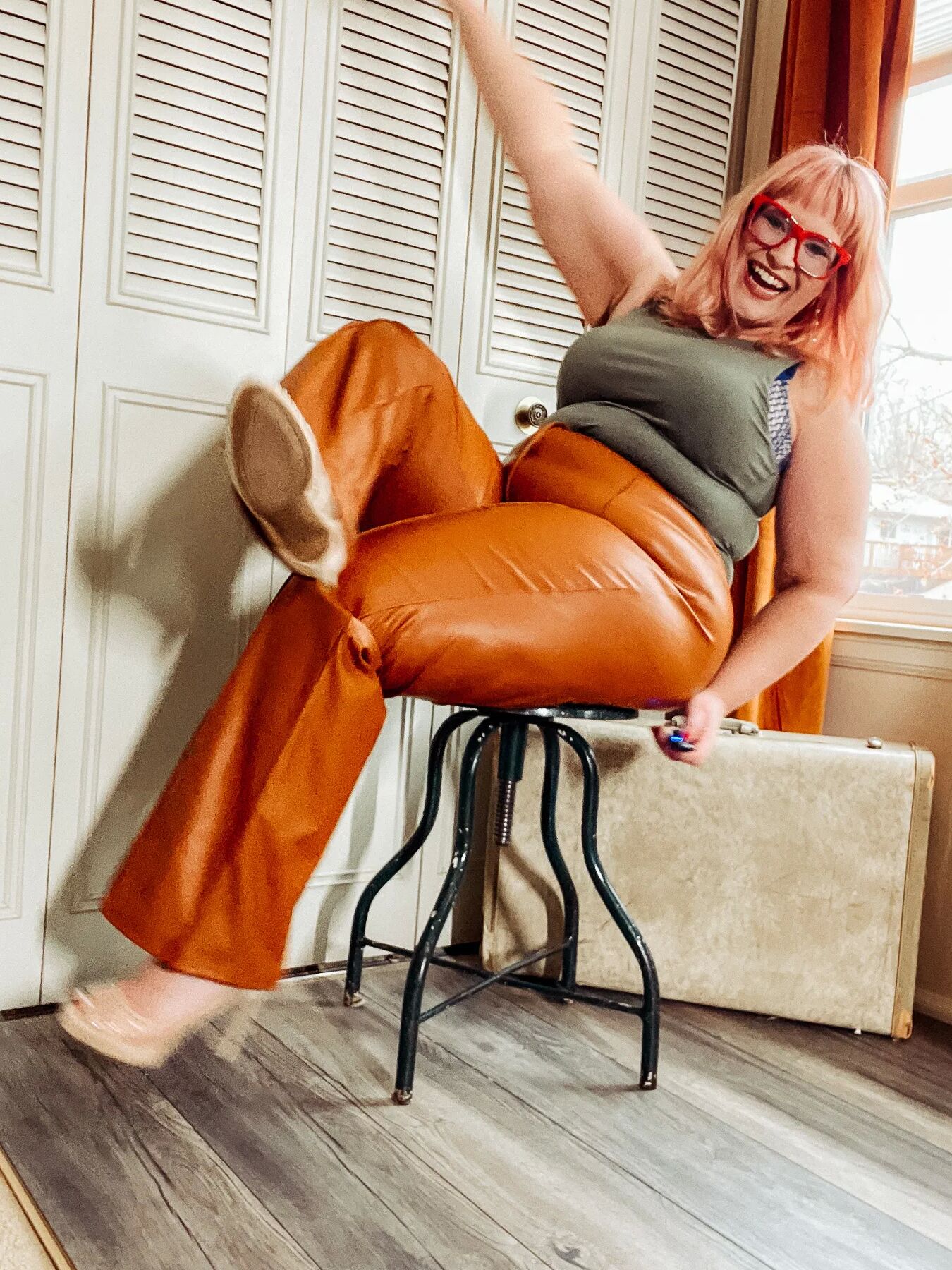 BBW in tight leather pants leans over and shows off her ass