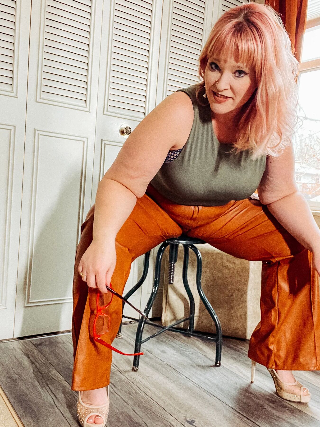 BBW in tight leather pants leans over and shows off her ass