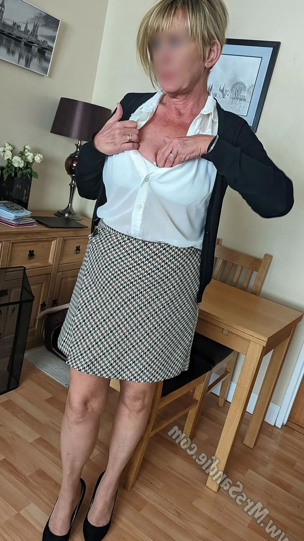 Ready for work in skirt, blouse, pantyhose and heels.