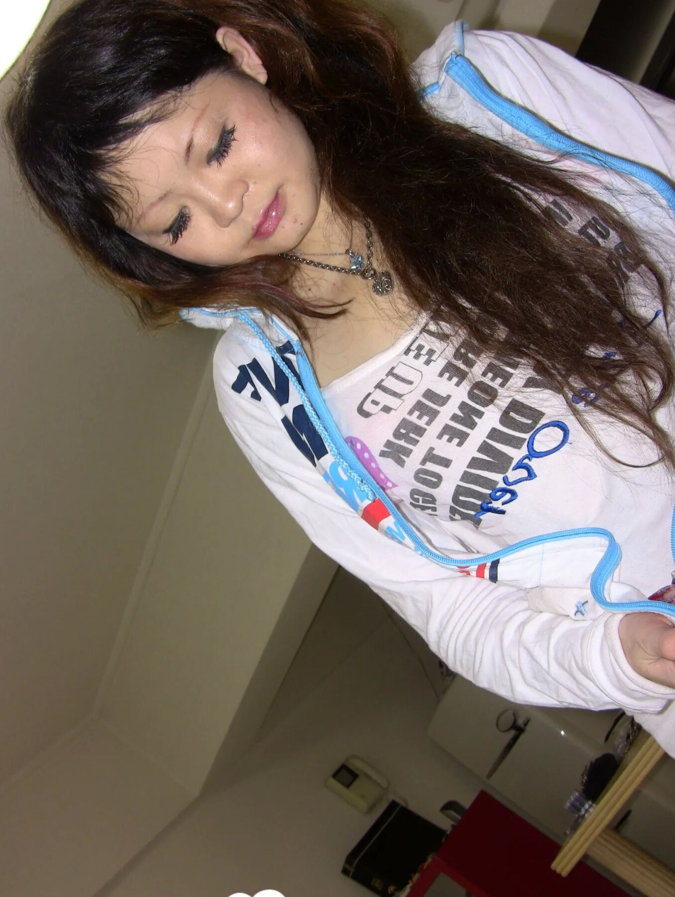 Stunning Asian gets completely naked on camera