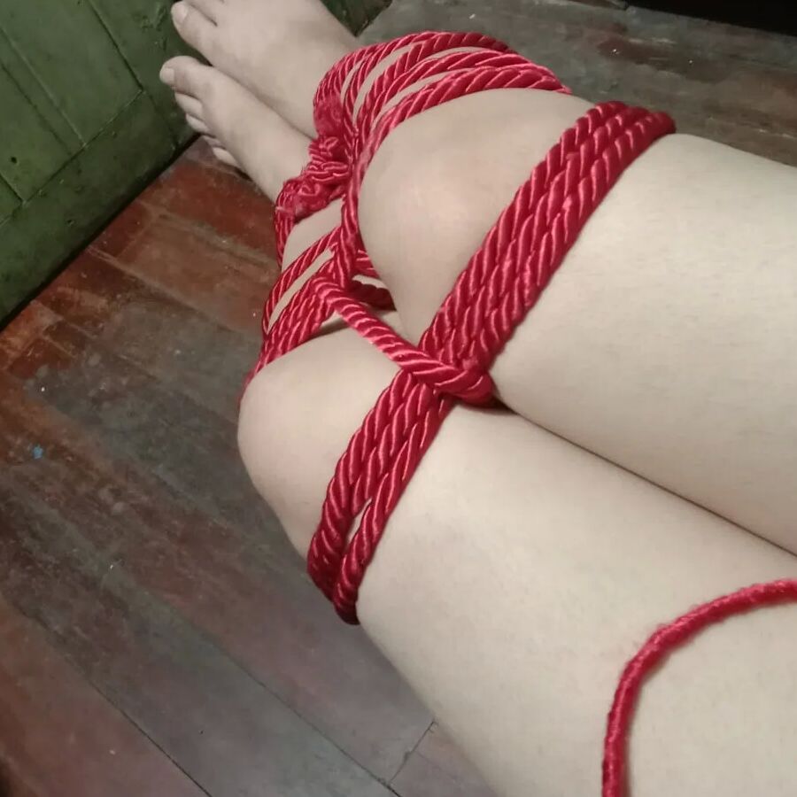 His white legs were tied with a red rope.