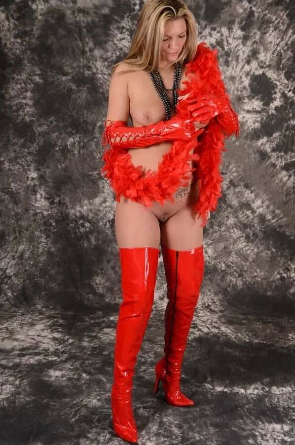 MILF Arabella May in red high boots, gloves & feather boa