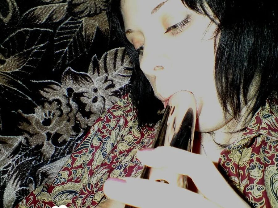 Smoking wife using a long metal dildo